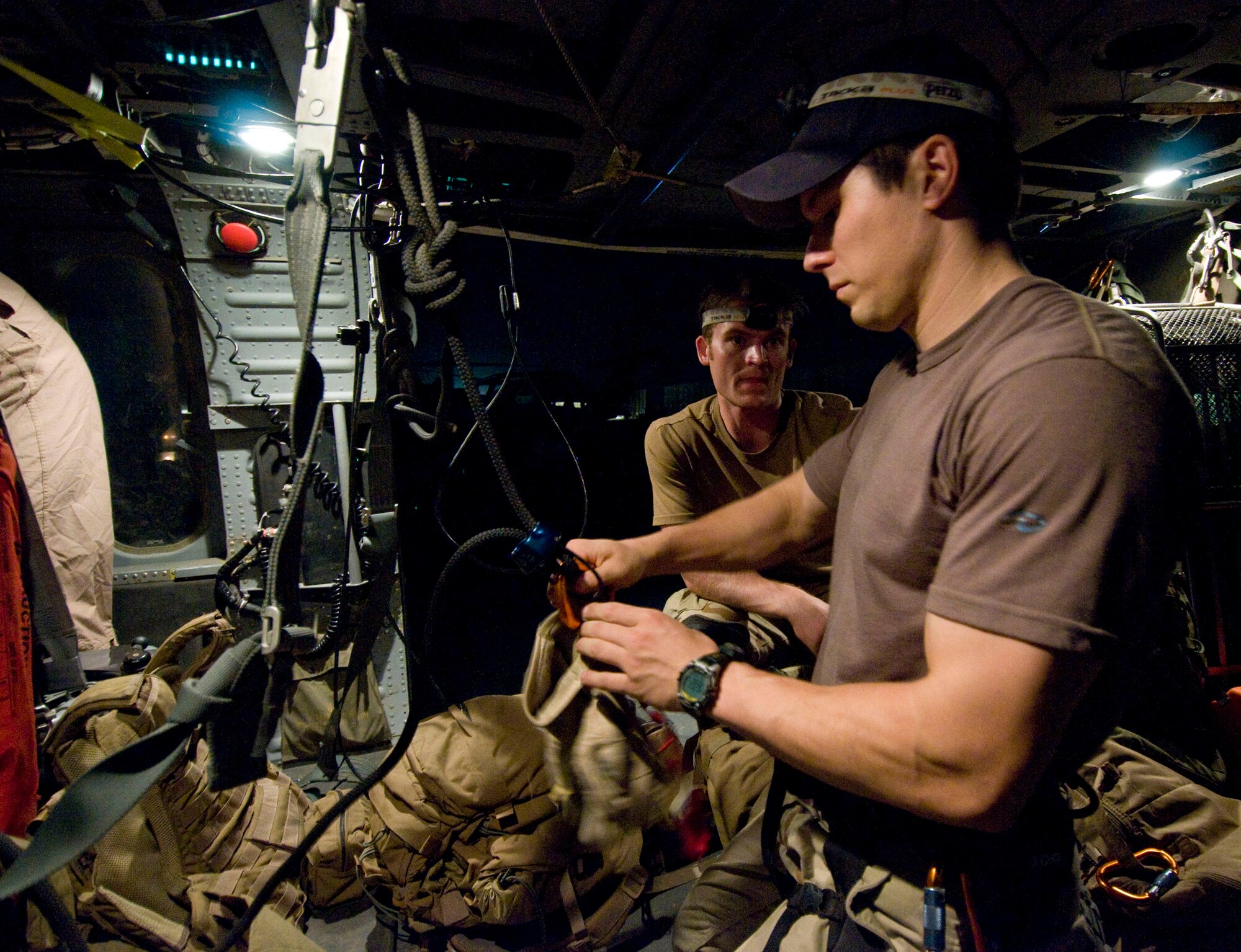BAGRAM AIR FIELD, Afghanistan -- Capt. Brock Roden of the 33rd Expeditionary Rescue Squadron pre-positions gear for flight in an HH-60G Pave Hawk here on July 17, 2008. Captain Roden participated in a combat search and rescue, or CSAR, exercise that night. Captain Roden is deployed from the 38th Rescue Squadron, Moody Air Force Base, Ga. (U.S. Air Force photo by Staff Sgt. Samuel Morse)