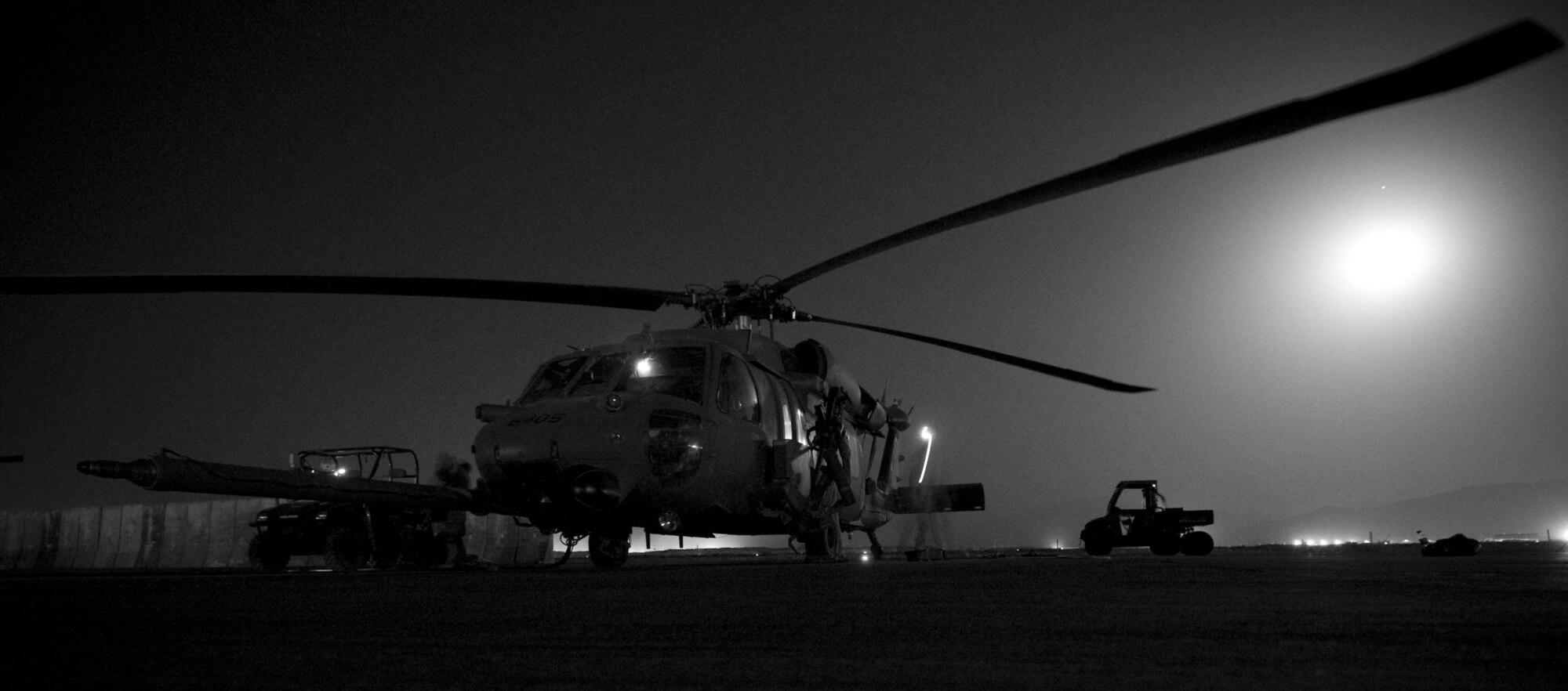 BAGRAM AIR FIELD, Afghanistan -- An aircrew arrives at an HH-60 Pave Hawk here on July 17, 2008. All HH-60Gs have an automatic flight control system, night vision goggles with lighting and forward looking infrared system that makes it possible to conduct night operations such as this. (U.S. Air Force photo by Staff Sgt. Samuel Morse)