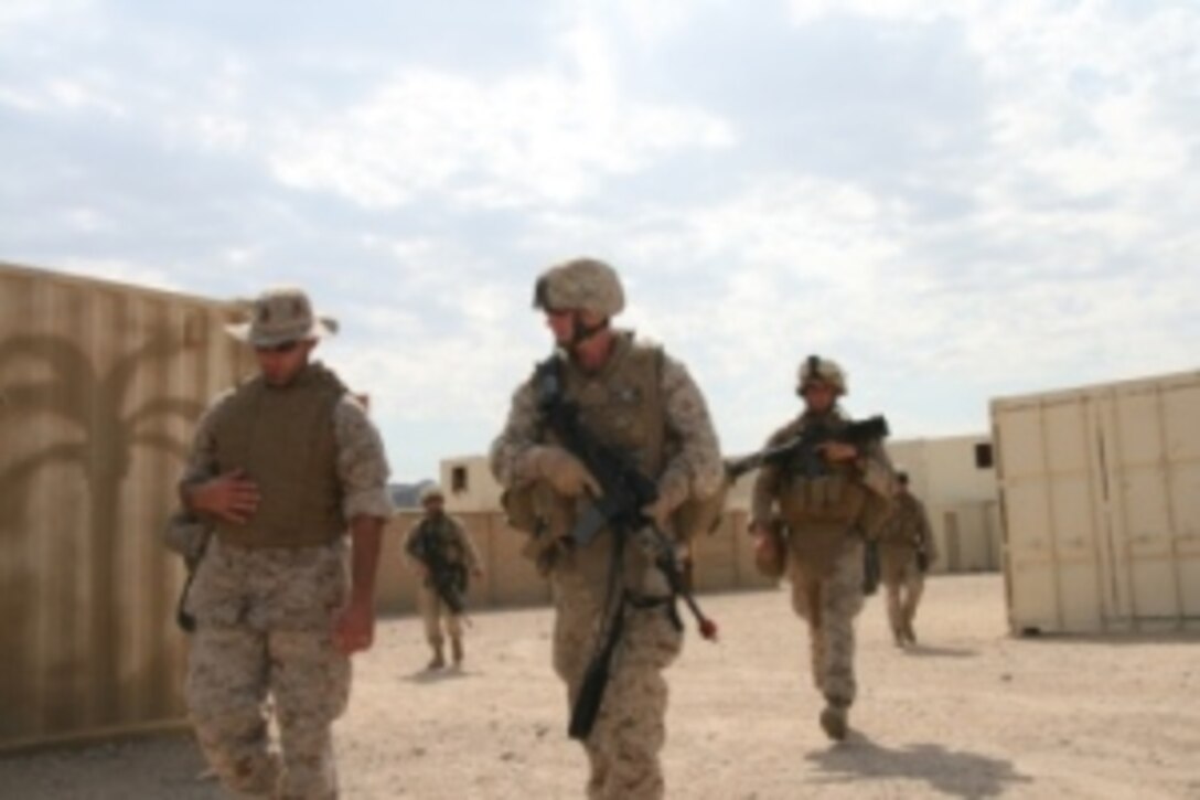 Suheil Sitto (left), a civilian interpreter and Iraq-native, escorts Maj. John Fitzsimmons of Company G, 2nd Battalion, 25th Marine Regiment to meet the sheik and mayor of “Wadi Al Sahara,” an urban training facility aboard Marine Corps Air-Ground Combat Center in Twentynine Palms, Calif. July 19, 2008.  Sitto conveyed the Marines’ plans to help the Iraqi community and assisted the sheik and mayor in voicing their concerns about food, water and essential services.  The role players, all native-born Iraqis, interact with the Marines using Arabic and non-verbal communication techniques, adding a sense of realism to the training scenario.