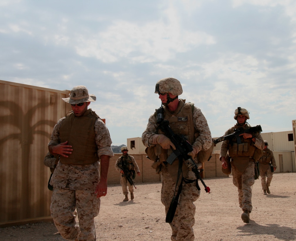 Marine Corps Reserve Maj. John Fitzsimmons (center), commanding officer of Company G, 2nd Battalion, 25th Marine Regiment, leads a patrol of Marines in an urban training facility aboard here July 19, 2008.  Fitzsimmons deployed to Iraq’s western Al Anbar Province with his company from the fall of 2008, conducting counterinsurgency operations in and around the rural town of Akashat.  In his civilian career, Fitzsimmons is a commercial real estate property manager for an international company based in New York City.