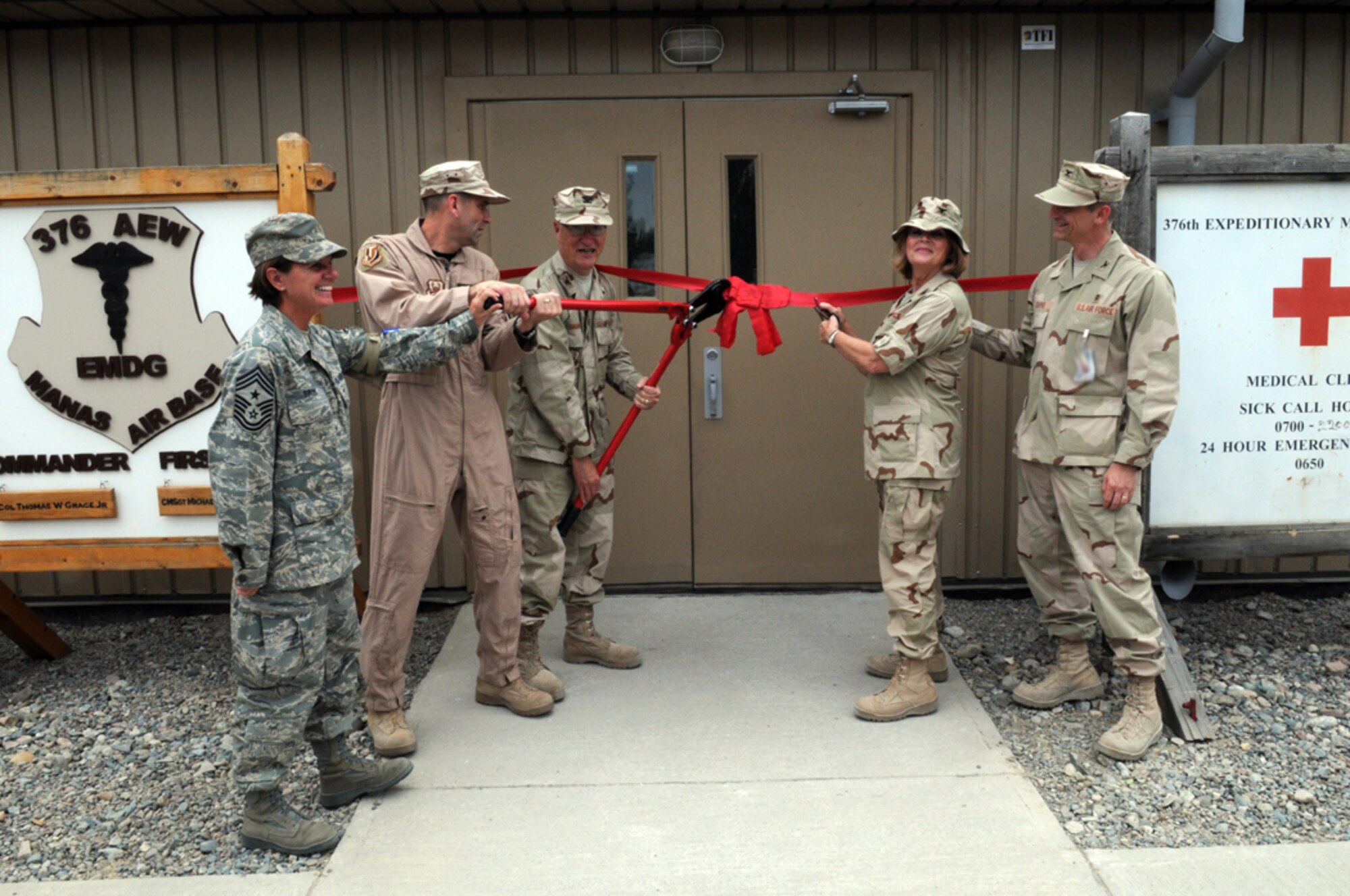 MANAS AIR BASE, KYRGYZ REPUBLIC--376th Air Expeditionary Wing commander, Col. Christopher Bence, and the 376th Expeditionary Medical Group commander, Col. (Dr.) Thomas Grace, prepare to cut the ribbon on the new hosptial here, July 17. The new medical facility replaces the tent hospital the 376th EMDG operated out of for nearly seven years. (Air Force photo / Airman 1st Class Ruth Holcomb) 
