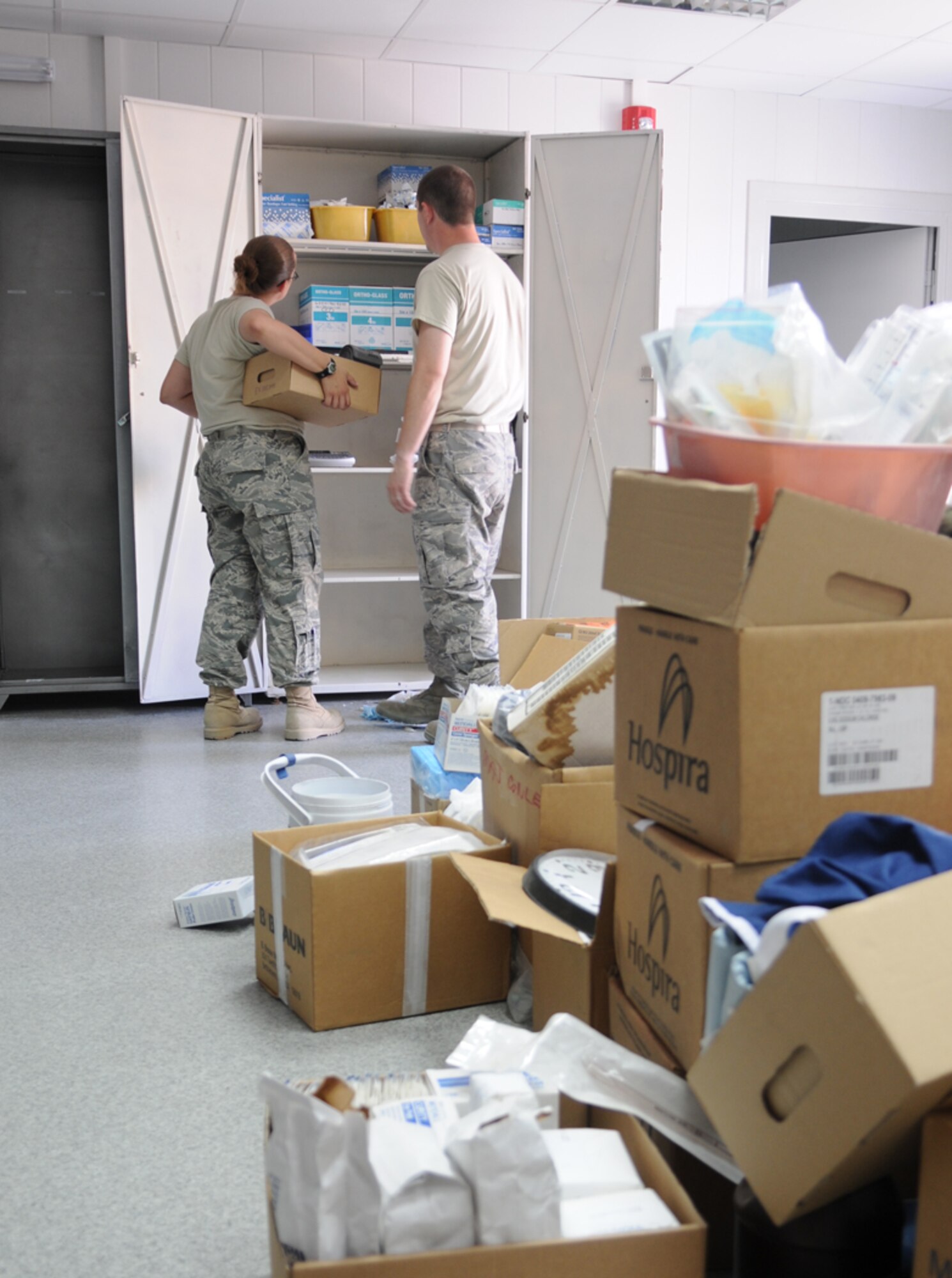 MANAS AIR BASE, KYRGYZ REPUBLIC--376th Expeditionary Medical Group personnel move medical supplies into the new medical building here, 15 July. After nearly seven years operating out of a tent facility, the 376th Expeditionary Medical Group held a ribbon cutting ceremony for their new, permanent facility July 17. (Air Force photo / Airman 1st Class Ruth Holcomb)

