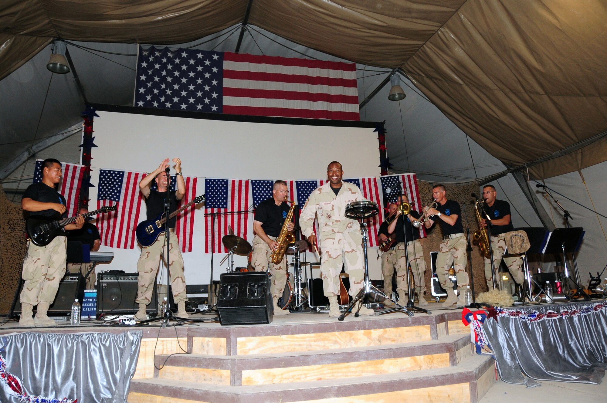 ALI BASE, Iraq -- Senior Master Sgt. McHudson Theodore, 407th Expeditionary Civil Engineer Squadron fire chief, plays along on the drums with the U.S. Air Forces Central Expeditionary Band ?Oasis? here July 18. The band was here for a few days to promote morale and host nation ties throughout the area of responsibility. Concerts were held at multiple locations around the base and at Camp Cedar II, a forward operating base in the area. Sergeant Theodore is deployed from Travis Air Force Base, Calif. (U.S. Air Force photo/Tech. Sgt. Sabrina Johnson)