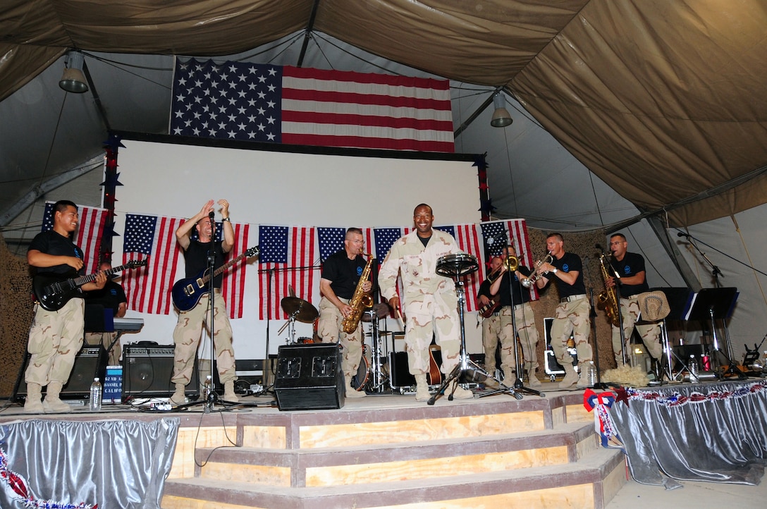 ALI BASE, Iraq -- Senior Master Sgt. McHudson Theodore, 407th Expeditionary Civil Engineer Squadron fire chief, plays along on the drums with the U.S. Air Forces Central Expeditionary Band ?Oasis? here July 18. The band was here for a few days to promote morale and host nation ties throughout the area of responsibility. Concerts were held at multiple locations around the base and at Camp Cedar II, a forward operating base in the area. Sergeant Theodore is deployed from Travis Air Force Base, Calif. (U.S. Air Force photo/Tech. Sgt. Sabrina Johnson)
