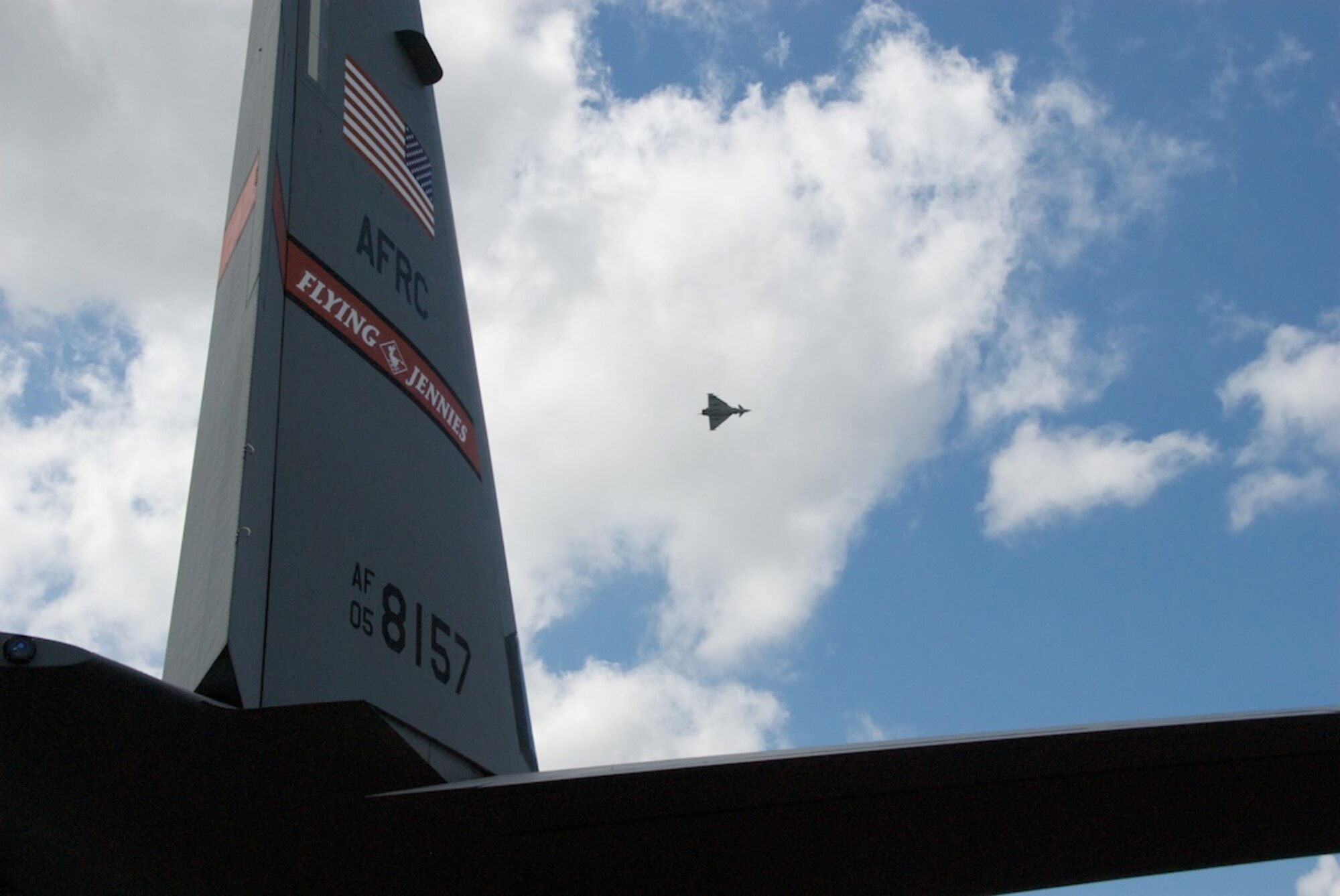 A Eurofighter Typhoon flies above the C-130J Super Hercules of the 815th Airlift Squadron Flying Jennies.  The Flying Jennies showcased the Air Force Reserve J-Model at the world's largest air show, Farnborough, England July 13-20, 2008.