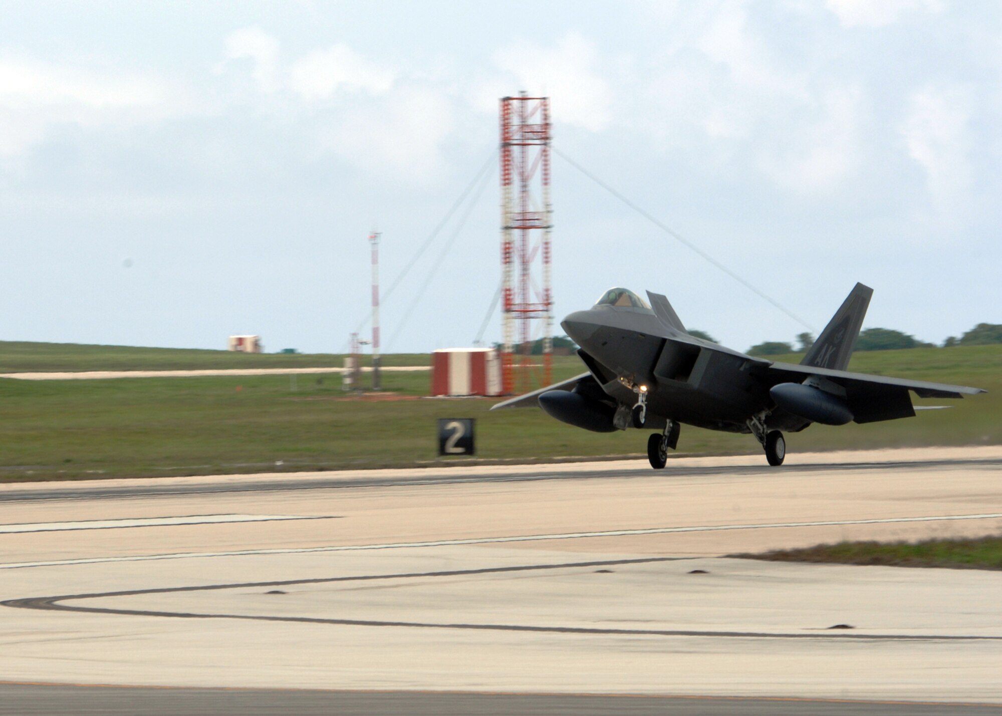 A U.S. Air Force F-22A Raptor assigned to the 90th Expeditionary Fighter Squadron, Elmendorf Air Force Base, Alaska lands at Andersen Air Force Base, Guam July 20. The F-22A Raptor is the Air Force's newest fighter aircraft. Its combination of stealth, supercruise, maneuverability, and integrated avionics, coupled with improved supportability, represents an exponential leap in warfighting capabilities. The Raptor performs both air-to-air and air-to-ground missions allowing full realization of operational concepts vital to the 21st century Air Force.  (U.S. Air Force by Airman 1st Class Courtney Witt)