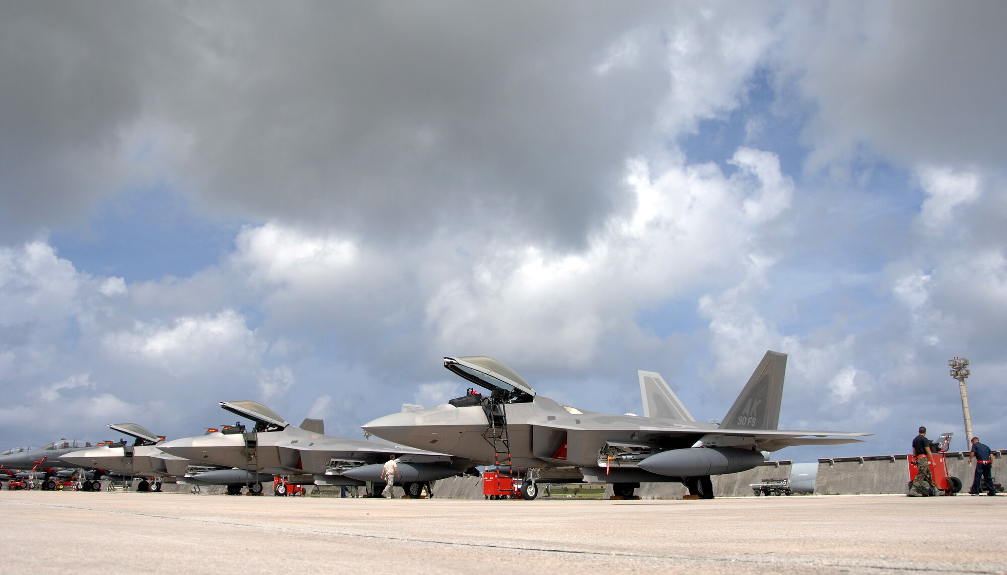 Five U.S. Air Force F-22A Raptors join 16 F-15E Strike Eagles on the flightline of Andersen Air Force Base, Guam July 20. Although this is the second time that F-22A's have been deployed to Guam, this is the first time F-22A’s assigned to the 90th Expeditionary Fighter Squadron Elmendorf Air Force Base, Alaska have come here. The deployment to   Andersen demonstrates the continued U.S. commitment to fulfill security responsibilities throughout the Western Pacific and to maintain peace in the region.
(U.S. Air Force by Airman 1st Class Courtney Witt)
