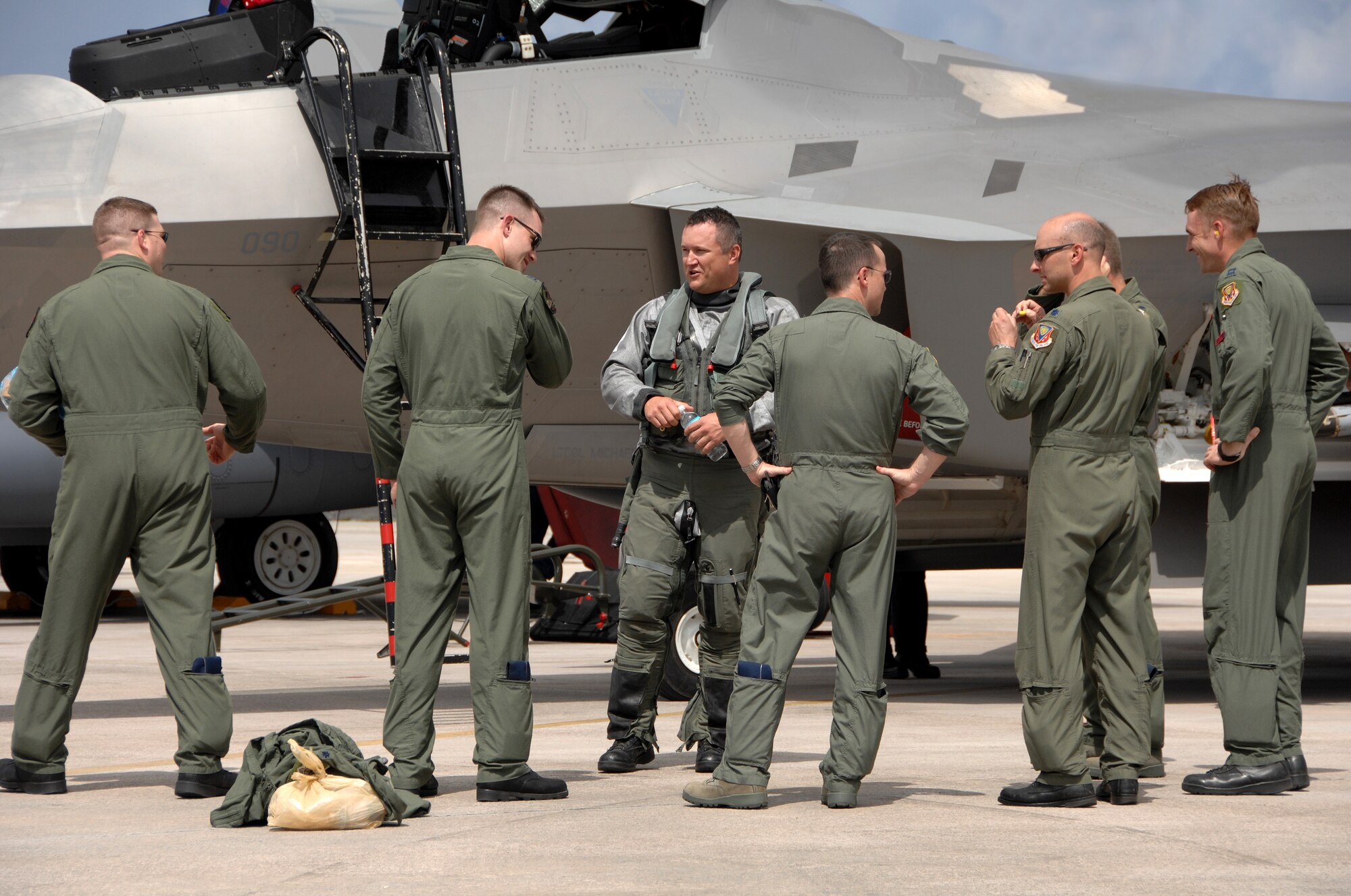 Lt. Col. Mike Shower, commander of the 90th Expeditionary Fighter Squadron, speaks with his pilots after landing on Andersen Air Force Base, Guam July 20. Although this is the second time that F-22A's have been deployed to Guam, this is the first time F-22A’s assigned to the 90th Expeditionary Fighter Squadron Elmendorf Air Force Base, Alaska have come here.  (U.S. Air Force by Airman 1st Class Courtney Witt)