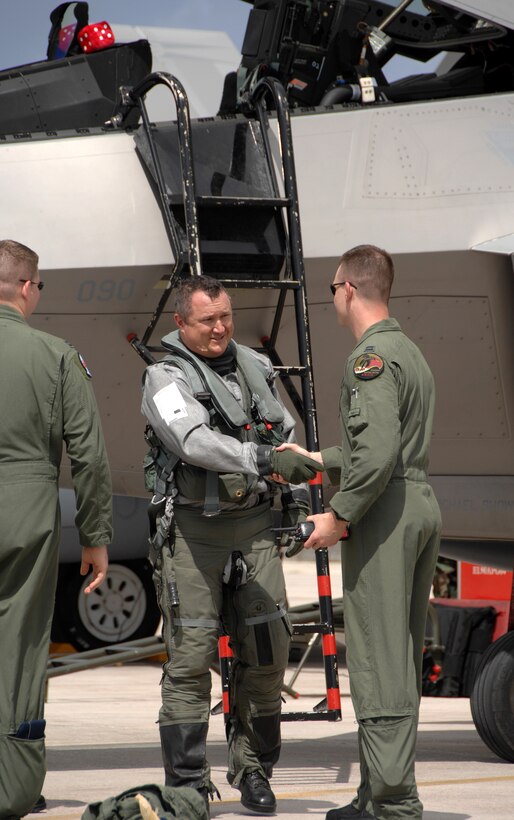 Lt. Col. Mike Shower, 90th Expeditionary Fighter Squadron commander, and F-22A pilot Capt. Bill Creeden shake hands after landing at Andersen Air Force Base, Guam, July 20. Although this is the second time that F-22A's have been deployed to Guam, this is the first time F-22A’s assigned to the 90th Expeditionary Fighter Squadron, Elmendorf Air Force Base, Alaska have come here.  The F-22A's along with associated maintenance and support personnel, are here to participate in the Jungle Shield exercise and conduct Cope Thaw training. (U.S. Air Force by Airman 1st Class Courtney Witt)
