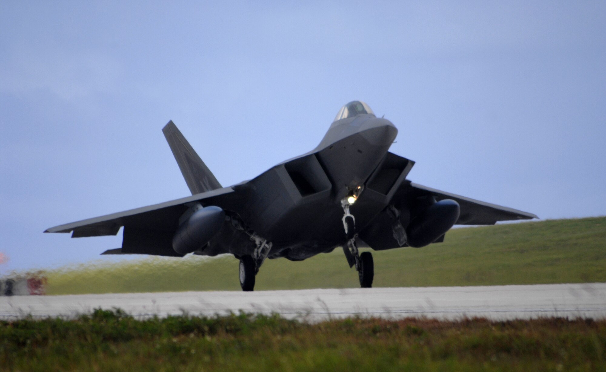 A U.S. Air Force F-22A Raptor assigned to the 90th Expeditionary Fighter Squadron out of Elmendorf Air Force Base, Alaska lands at Andersen Air Force Base, Guam July 20. The F-22A Raptor is the Air Force's newest fighter aircraft. Its combination of stealth, supercruise, maneuverability, and integrated avionics, coupled with improved supportability, represents an exponential leap in warfighting capabilities. The Raptor performs both air-to-air and air-to-ground missions allowing full realization of operational concepts vital to the 21st century Air Force.  (U.S. Air Force by Airman 1st Class Courtney Witt)