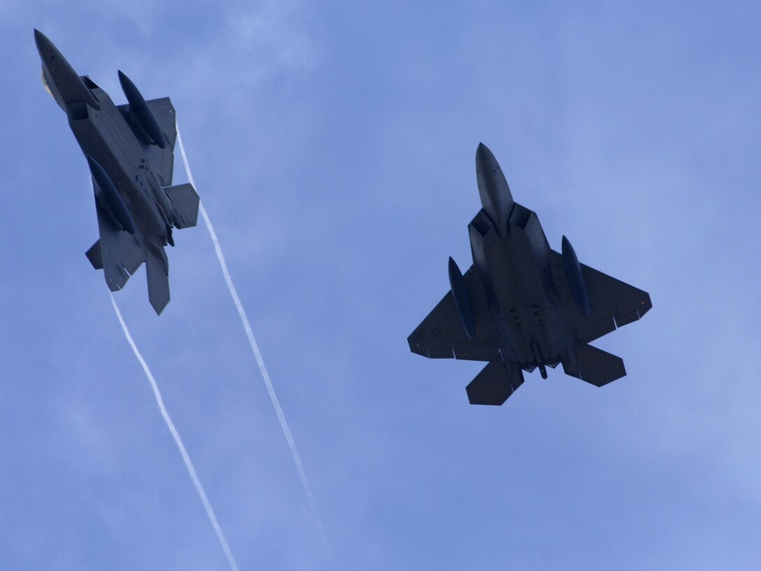 U.S. Air Force F-22A Raptors fly high above Andersen Air Force Base Guam July 20. The F-22As, along with associated maintenance and support personnel, are deployed on Guam to participate in the Jungle Shield exercise and conduct Cope Thaw training. (U.S. Air Force by Airman 1st Class Courtney Witt)