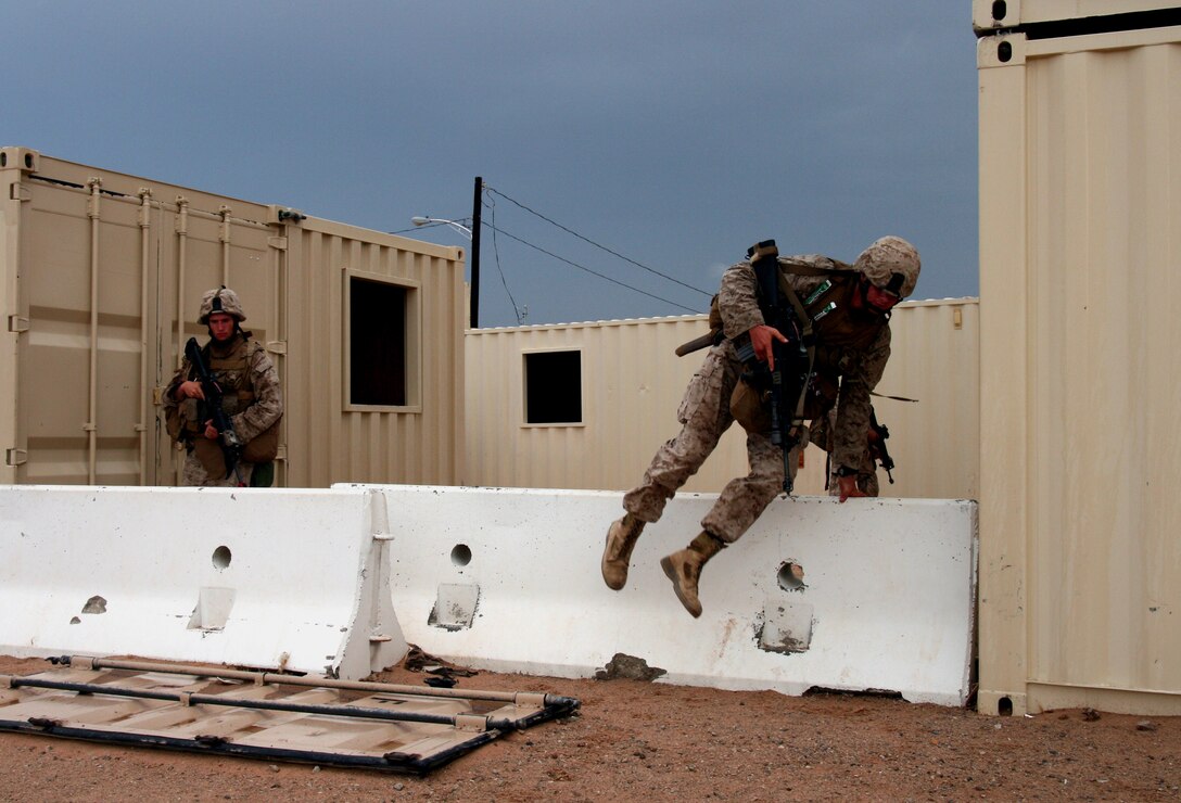Reserve Marines from 3rd Platoon, Company G, 2/25 maneuver through Wadi Al Sahara during a patrol on the morning of July 20.  This notional Iraqi town at Marine Corps Air Ground Combat Center here is used as an urban warfare training facility for Marines bound for overseas deployments.