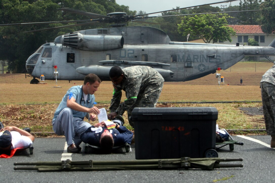 Medics tend to patients as a CH-53 Delta from HMH-362 prepares for lift off of a  after dropping off casualties from the USS O'Kane during a mass caualty exercise for the 2008 RIMPAC Exercise here July 21.
