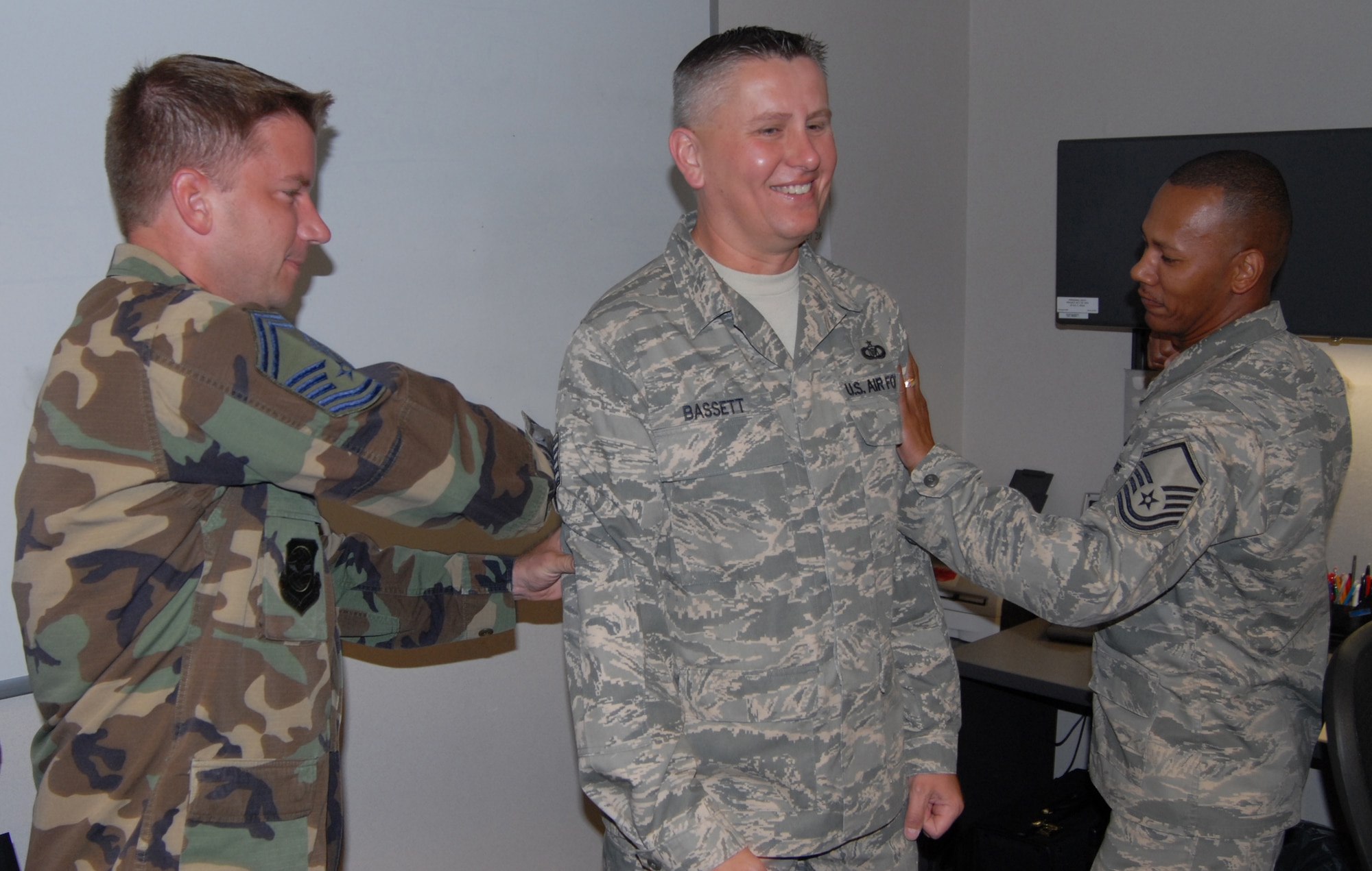 New Master Sgt. William Bassett shares a smile and congratulations from other sergeants following his promotion and new stripe this month at the 932nd Airlift Wing, Scott Air Force Base, Ill. Photo/Maj. Stan Paregien