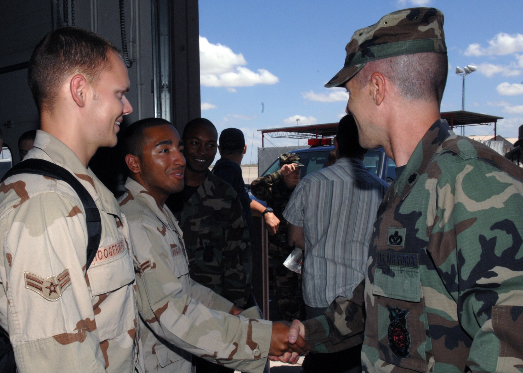 Airman 1st Class Christopher Hoogerwerf and Airman 1st Class Gianno Nogueras are greeted by the 49th Civil Engineer Squadron's Commander, Lt Col Michael Myers on July 19 Holloman Air Force Base, N.M. The firefighters return from a four month deploment to Manas Air Base. 

(U.S. Air Force photo/Senior Airman Anthony Nelson Jr)
