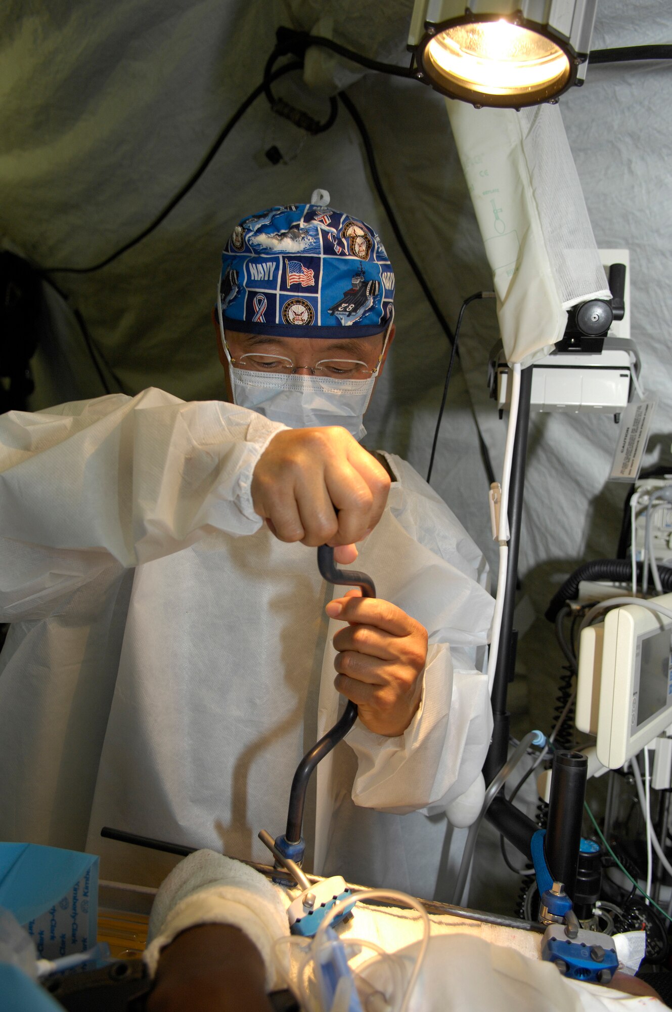BAMAKO, Mali -- U.S. Navy Capt. William Oh operates on a Malian ?patient? during the Mass Casualty portion of MEDFLAG 08, July 18, 2008.  More than 90 servicemembers deployed to Bamako, Mali, for MEDFLAG 08, a multi-national medical training exercise designed to enhance medical capabilities and readiness for U.S. and African Forces.  Captain Oh is deployed from Naval Operational Support Unit, Toledo, Ohio.  (U.S. Air Force photo/Senior Airman Michael S. Dorus)
