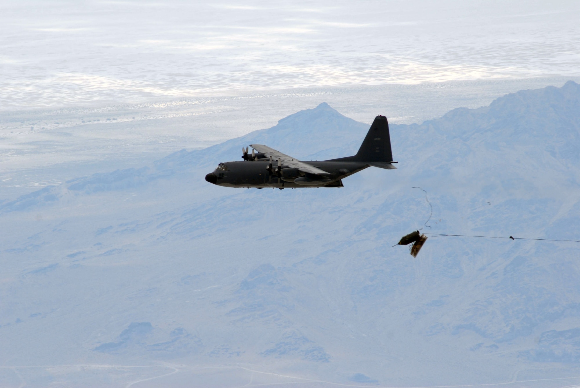 An MC-130E Combat Talon I from the 919th Special Operations Wing from Duke Field, Fla., drops the last operational 15,000-pound BLU-82 bomb July 15 at the Utah Test and Training Range. (U.S. Air Force photo/Capt. Patrick Nichols) 
