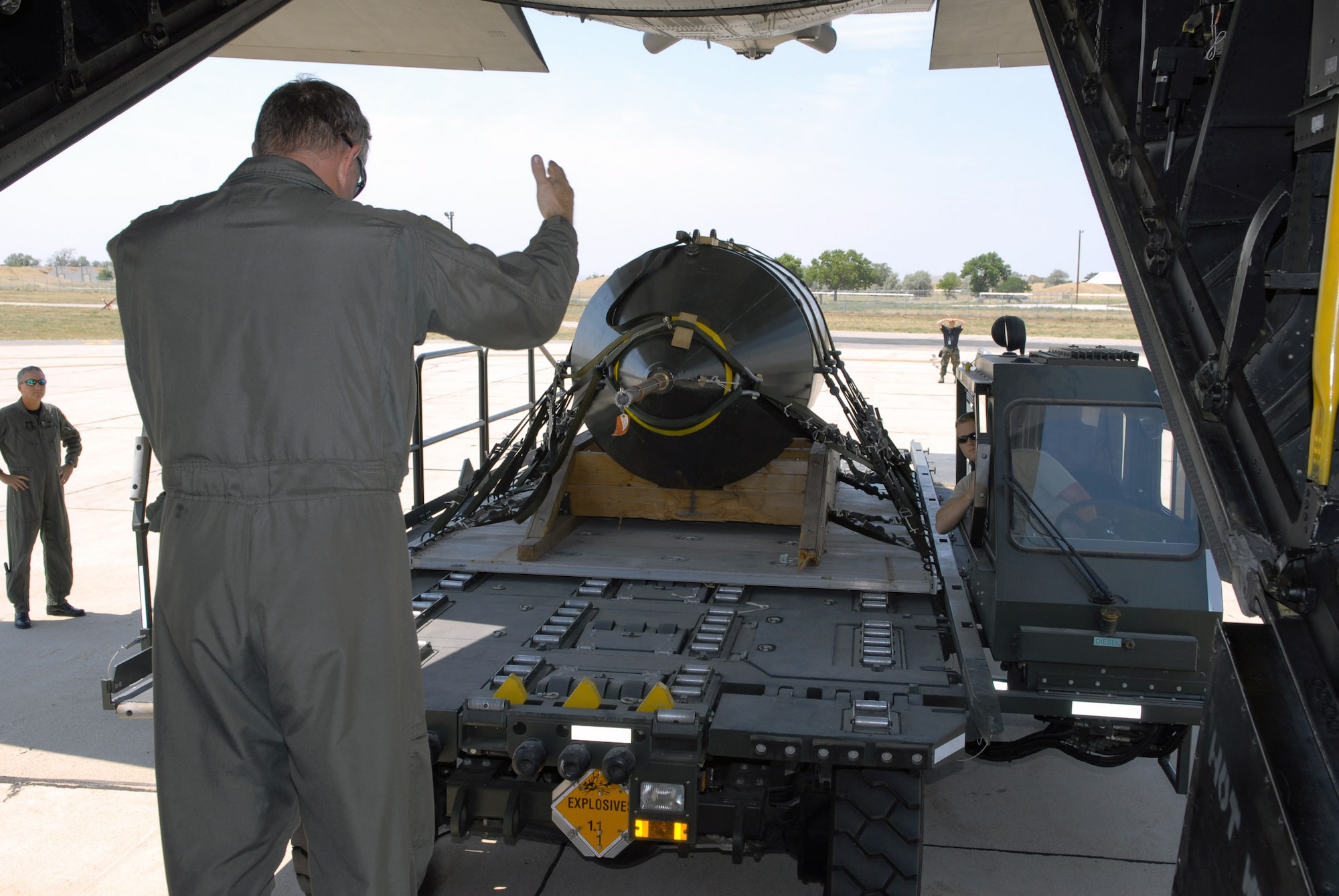 Tech. Sgt. Brian Scott guides the uploading of the last 15,000-pound BLU-82 bomb aboard an MC-130E Talon I shortly before it was dropped July 15 at the Utah Test and Training Range. Sergeant Scott is a loadmaster with the 711th Special Operations Squadron, Duke Field, Fla. (U.S. Air Force photo/Capt. Patrick Nichols) 
