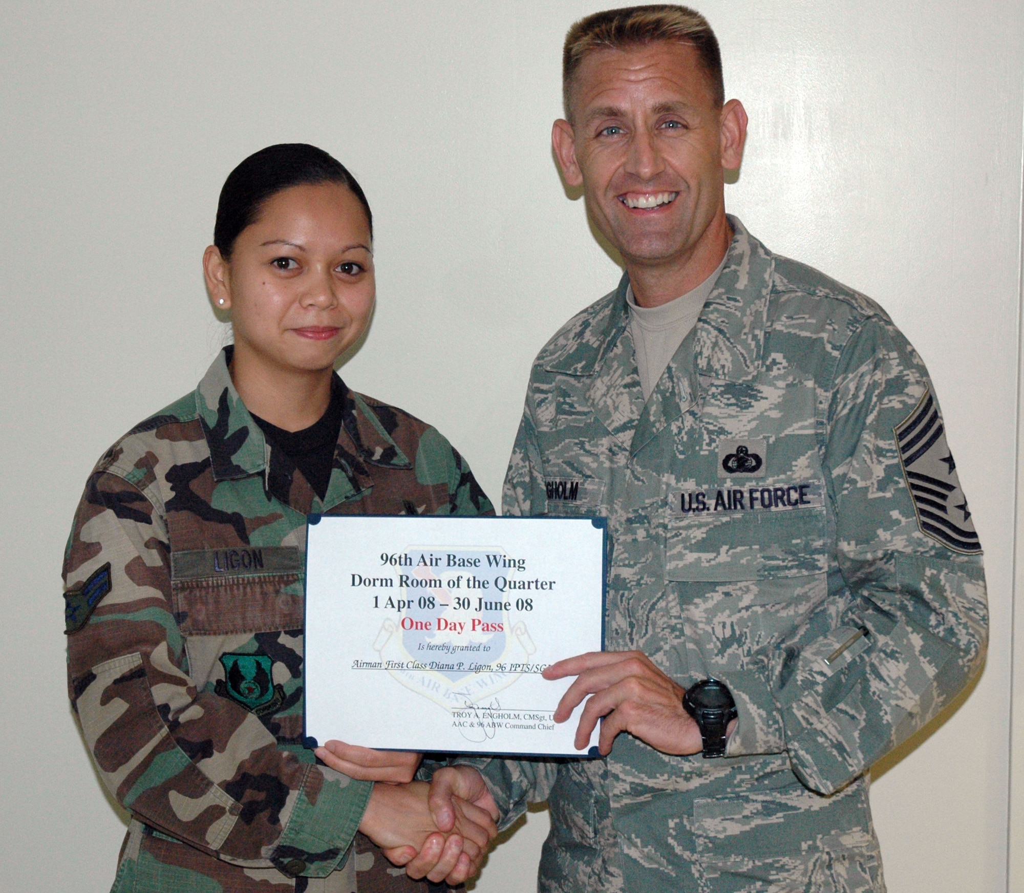 EGLIN AIR FORCE BASE, Fla. -- Chief Master Sgt. Troy Engholm, 96th Air Base Wing command chief, presents Airman 1st Class Diana Ligon with a one-day pass, certificate and other certificates for a job well done for winning the Room of the Quarter competition. (US Air Force photo/ Airman 1st Class Anthony Jennings