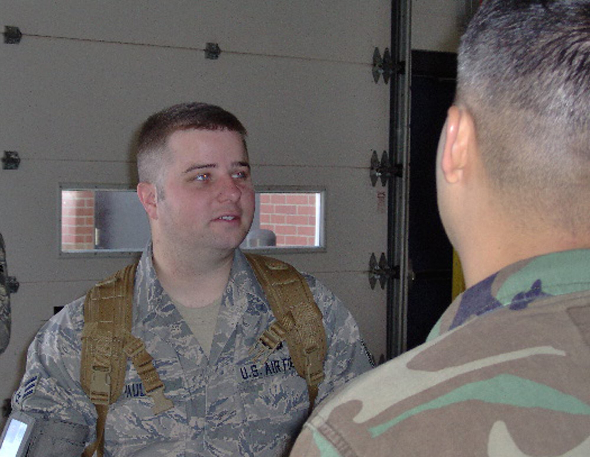 Senior Airman Dallas Pauls, 90th Missile Maintenance Squadron, speaks with friends and coworkers recently before he left for a deployment (Courtesy photo).