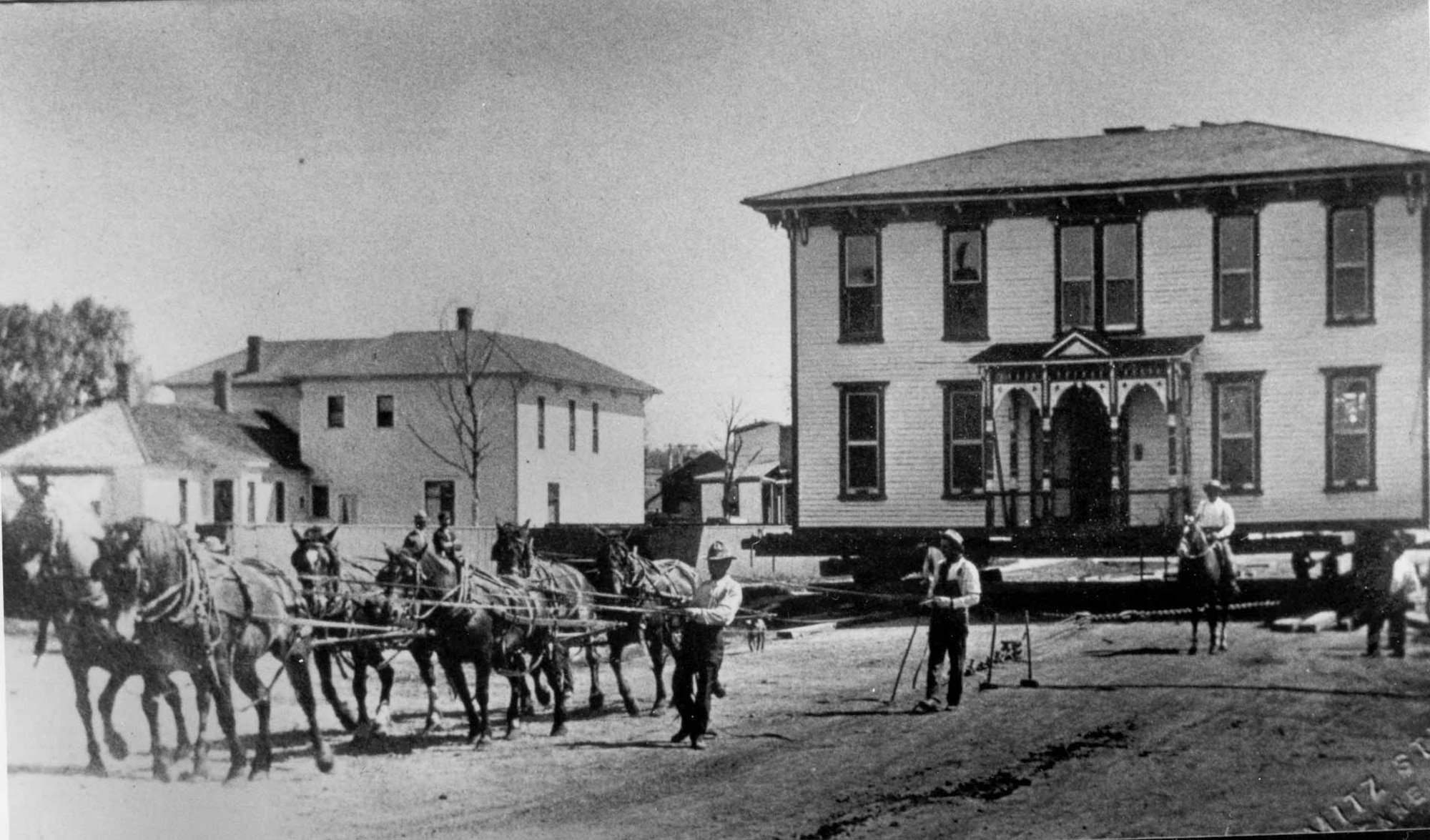 Settlers move a house with the help of horses and logs during the late 1800s. Many homes were constructed and then sold for prices from $40 for a one-story house to $72 to $85 for a two-story house (Courtesy photo).