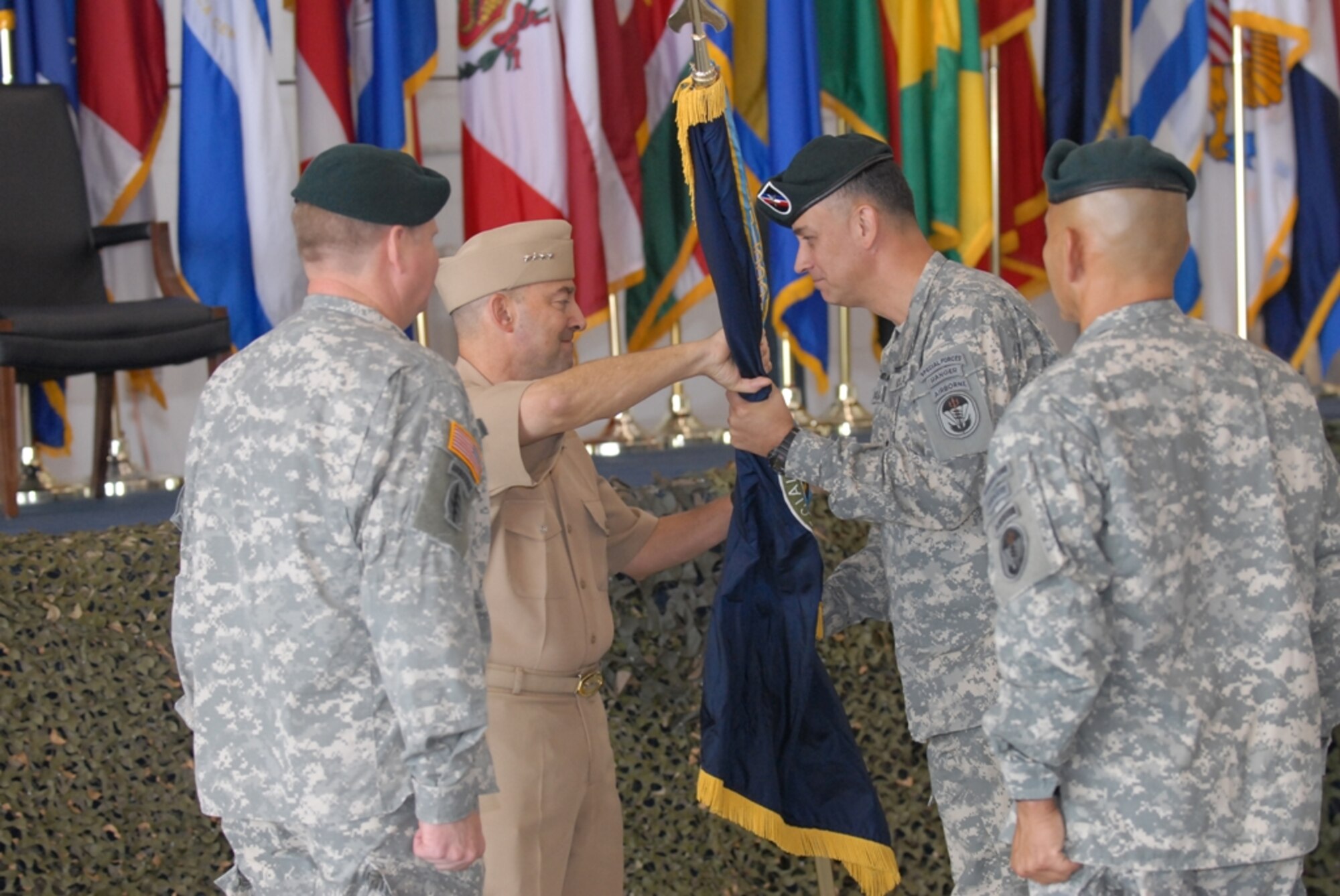 SOUTHCOM Commander, Adm. James G. Stavridis hands over the command colors to Brig. Gen. Hector Pagan during the change of command ceremony at Homestead Air Reserve Base, Fla., on July 18. (U.S. Army Photo by Sgt. 1st Class Felix A. Figueroa, SOCSOUTH PAO)