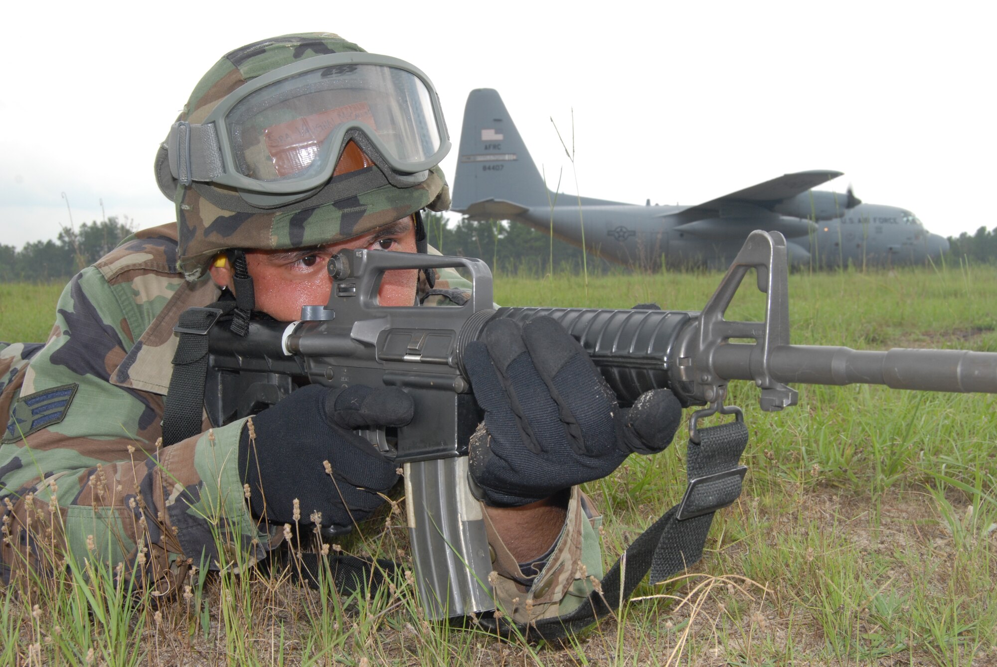 Senior Airman Vaughn Mccallum, 43rd Aeromedical Evacuation Squadron, provides defense for an aircraft preparing to take off during Mobile Aeromedical Staging Facility training at Fort Bragg's Camp Mackall July 10. (U.S. Air Force Photo by Staff Sgt. Jon LaDue)