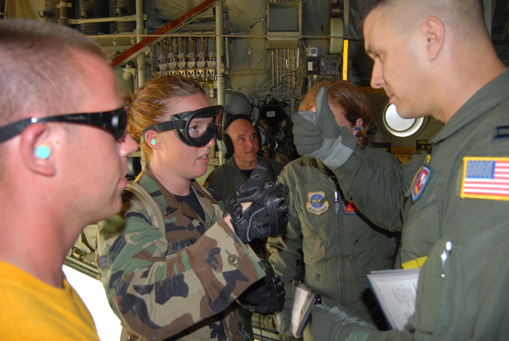 Capt. Stephen Urban, 375th Aeromedical Evacuation Squadron, explains the layout of the C-130H to Senior Airman Holly Jansenius, 60th Inpatient Operations Squadron, during Mobile Aeromedical Staging Facility training at Fort Bragg's Camp Mackall July 10. (U.S. Air Force Photo by Staff Sgt. Jon LaDue)