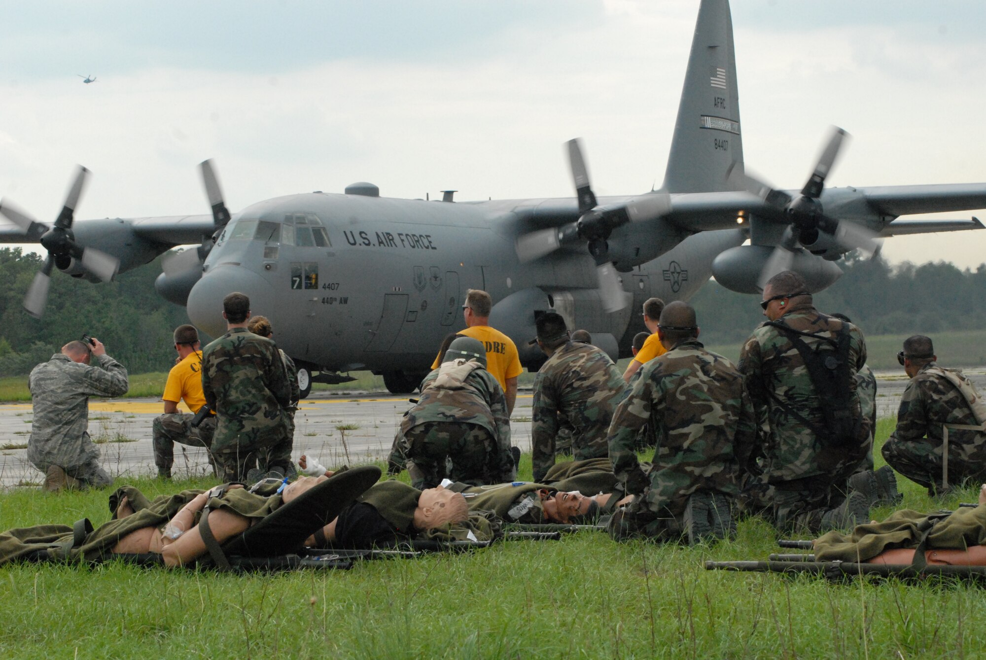 Airmen from the 60th Medical Group at Travis Air Force Base, Calif. and instructors from the 43rd Aeromedical Evacuation Squadron at Pope Air Force Base, N.C. prepare to load litters on an approaching C-130H during Mobile Aeromedical Staging Facility training at Fort Bragg's Camp Mackall July 10. (U.S. Air Force Photo by 2nd Lt. Chris Hoyler)