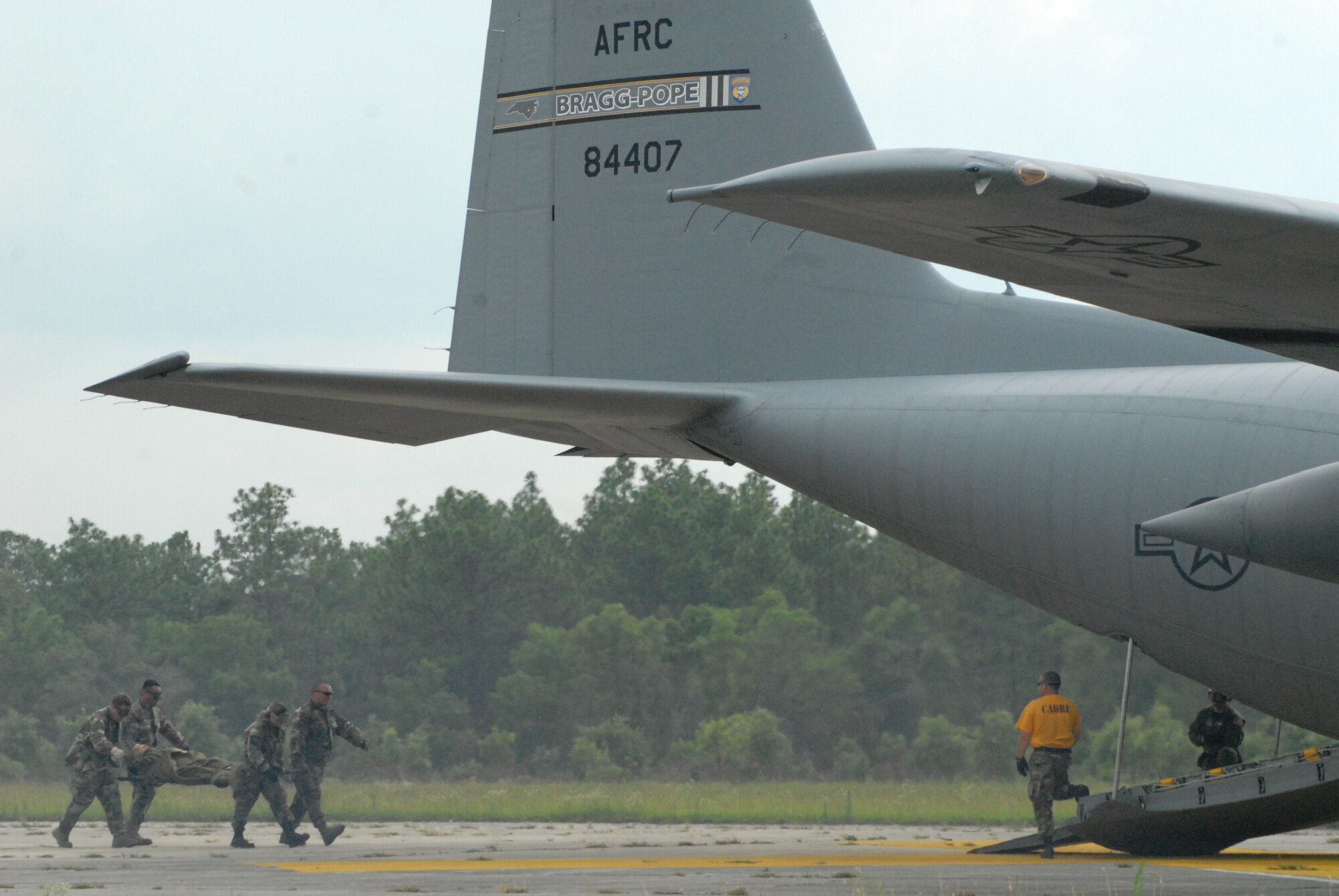 Airmen from the 60th Medical Group at Travis Air Force Base, Calif. load a litter on to a Pope Air Force Base C-130H during Mobile Aeromedical Staging Facility training at Fort Bragg's Camp Mackall July 10. (U.S. Air Force Photo by 2nd Lt. Chris Hoyler)