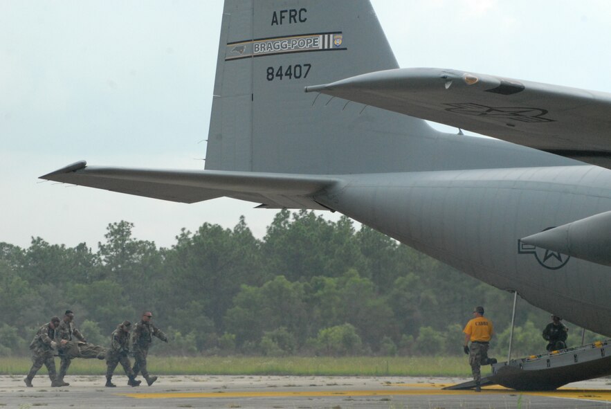 Airmen from the 60th Medical Group at Travis Air Force Base, Calif. load a litter on to a Pope Air Force Base C-130H during Mobile Aeromedical Staging Facility training at Fort Bragg's Camp Mackall July 10. (U.S. Air Force Photo by 2nd Lt. Chris Hoyler)