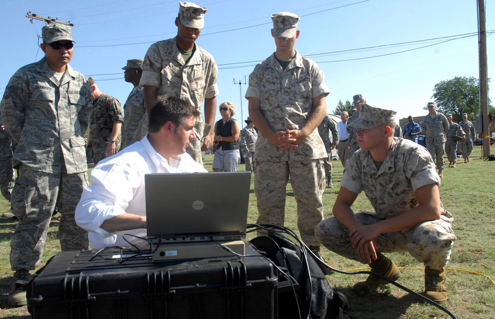CANNON AIR FORCE BASE, N.M. --  Roy Priest, Ground Antenna Transmit Receiver technology representative, briefs military personnel about the capabilities of the satellite dishes July 17. The servicemembers are participating in Joint Lightning, a combined service communications exercise that continues through July 25. (U.S. Air Force photo by Airman 1st Class Evelyn Chavez)