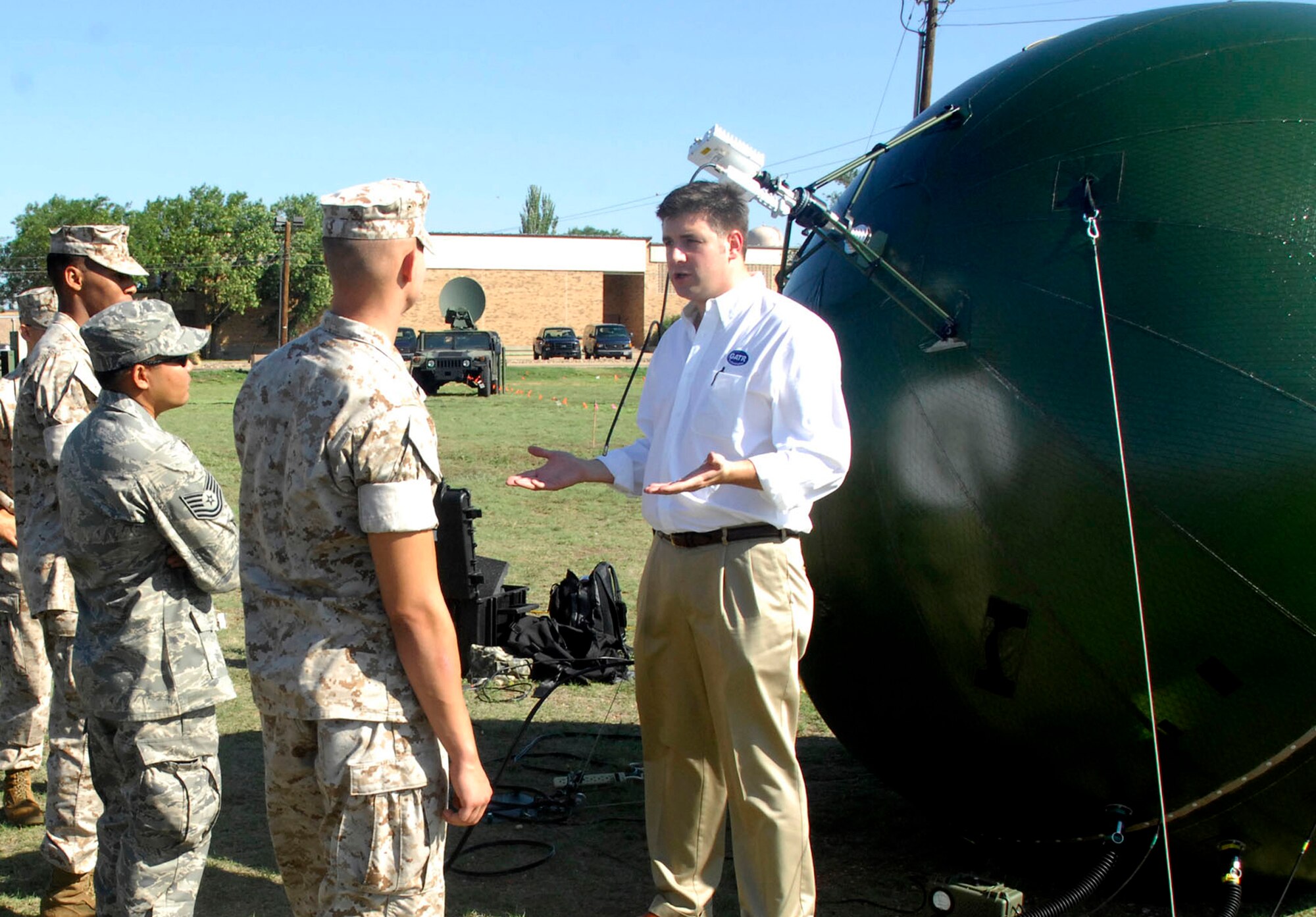 CANNON AIR FORCE BASE, N.M. -- Roy Priest, Ground Antenna Transmit Receiver technology representative, speaks to military personnel about the inflatable satellite July 17. Mr. Priest explained the uses of the prototype satellite during  Joint Lightning, a combined military communications exercise July 12-25. (U.S. Air Force photo by Airman 1st Class Evelyn Chavez)
