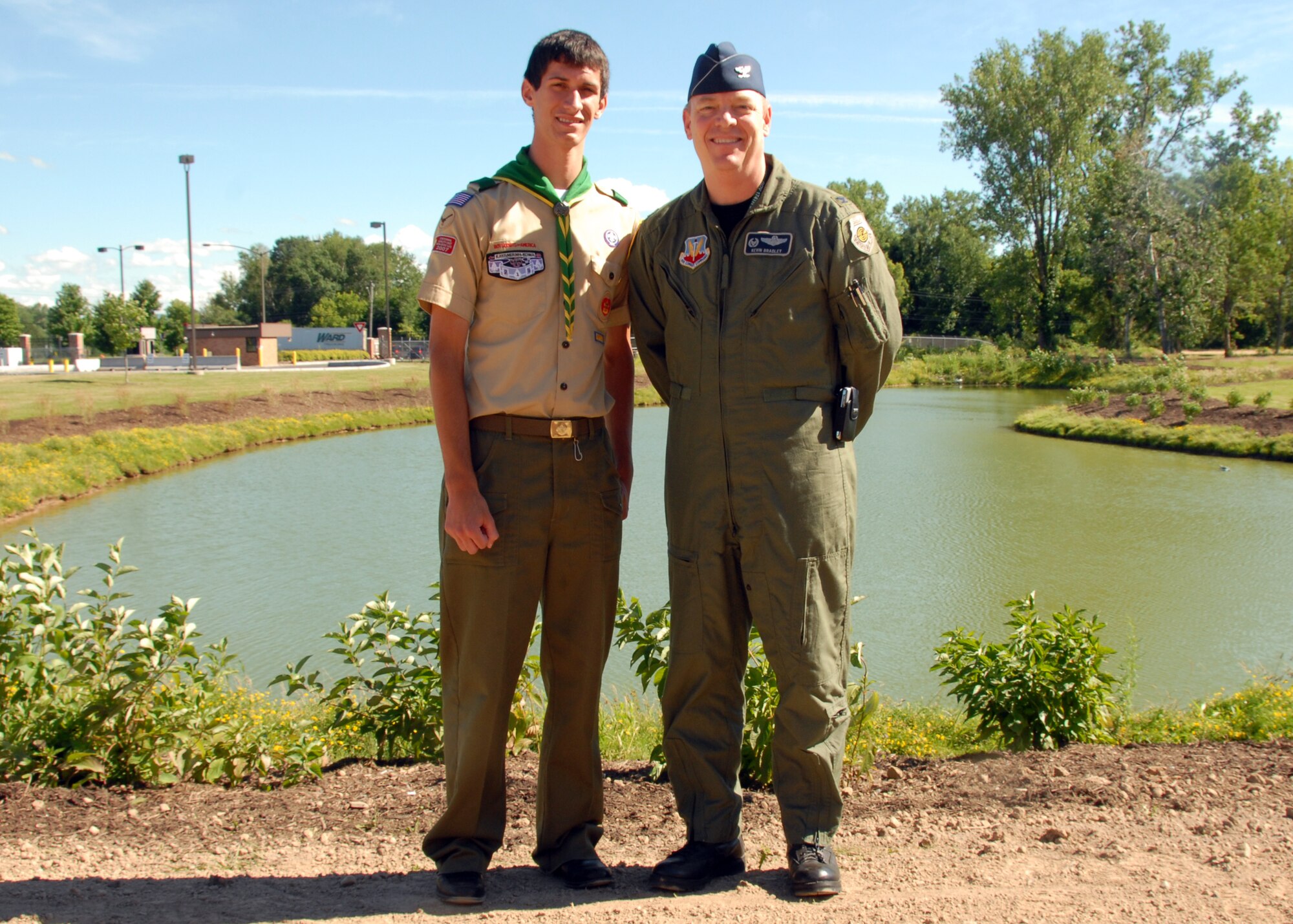 Michael Pizzarri, a member of Scout Troop 220, Syracuse, and 174th Fighter Wing Commander,Col. Kevin W. Bradley, stands at the Bldg 174th cooling pond.  The Eagle Scout candidate performed his Eagle Service Project on Hancock Field by planting 230 shrubs around the pond to mitigate goose populating the pond.  