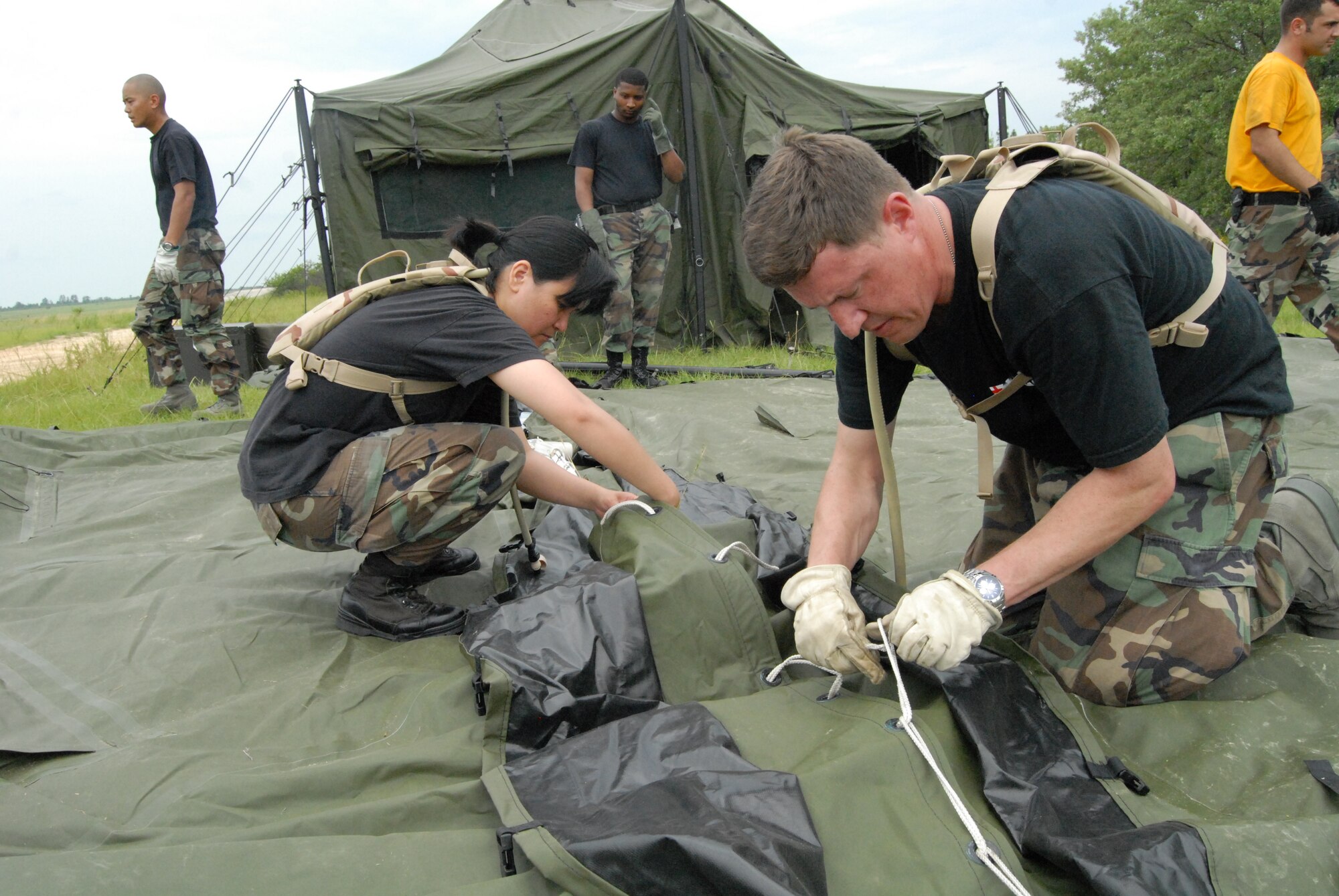 Maj. Maryann Marquez, 60th Medical Support Squadron and Master Sgt. Benjamin Kratzer, 60th Medical Operations Squadron, construct a second tent as part of their training with Pope's 43rd Aeromedical Evacuation Squadron July 8. The week-long training gave the Airmen from Travis' 60th Medical Group the experience as part of a Mobile Aeromedical Staging Facility before they possibly deploy as one later this year.
