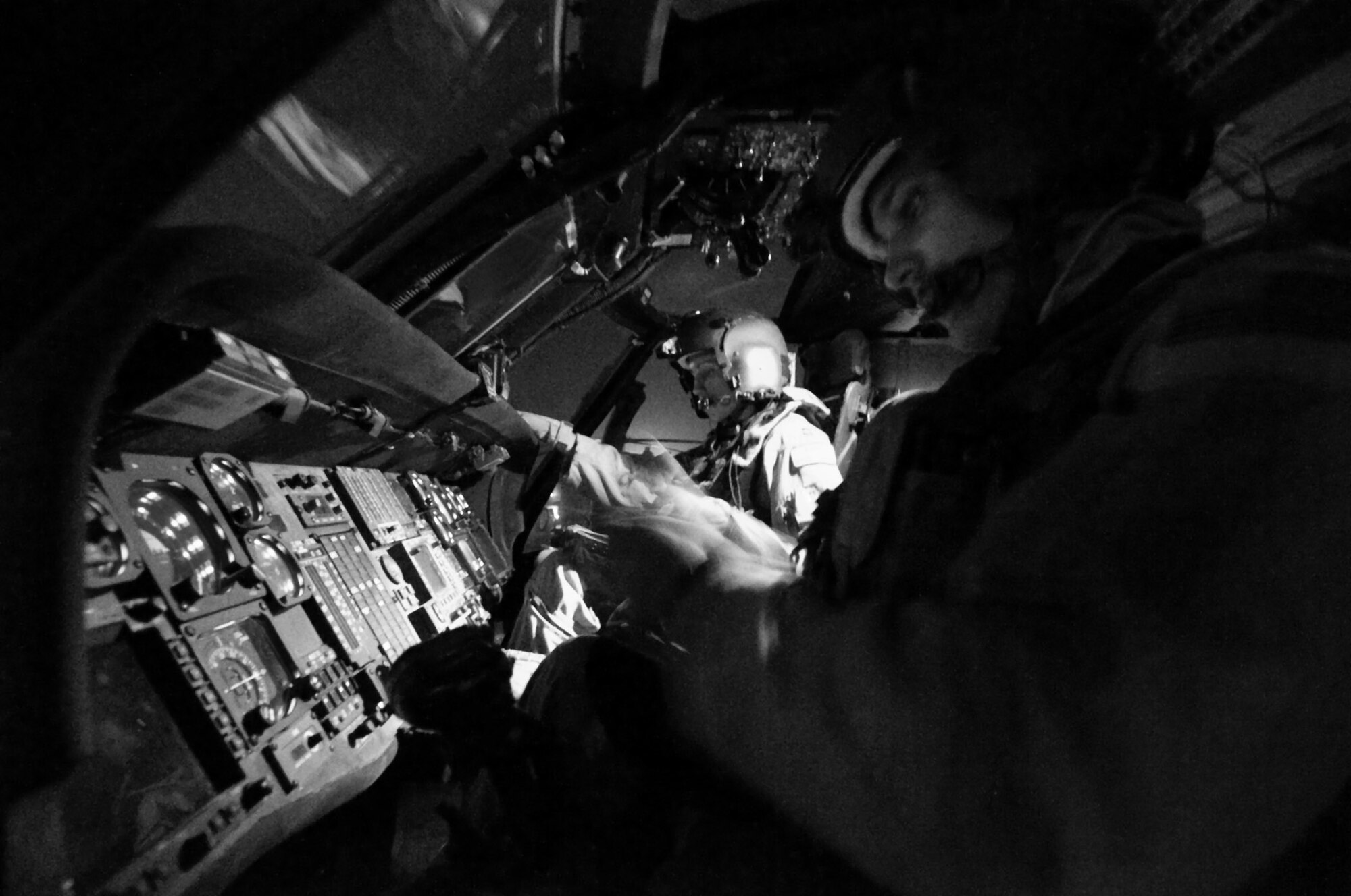 Capt. Jennifer Aupke (left) and 1st Lt. Thaddeus Ronnau double-check their gear and instrument readings July 17 at Bagram Air Base, Afghanistan. The HH-60G Pave Hawk helicopter features an upgraded communications and navigation suite that includes integrated inertial navigation/global positioning/Doppler navigation systems, satellite communications, secure voice, and Have Quick communications. Captain Aupke is an aircraft commander and flight lead, and Lieutenant Ronnau is a co-pilot. Both are assigned to the 33rd Expeditionary Rescue Squadron deployed from Kadena AB, Japan. (U.S. Air Force photo/Staff Sgt. Samuel Morse) 

