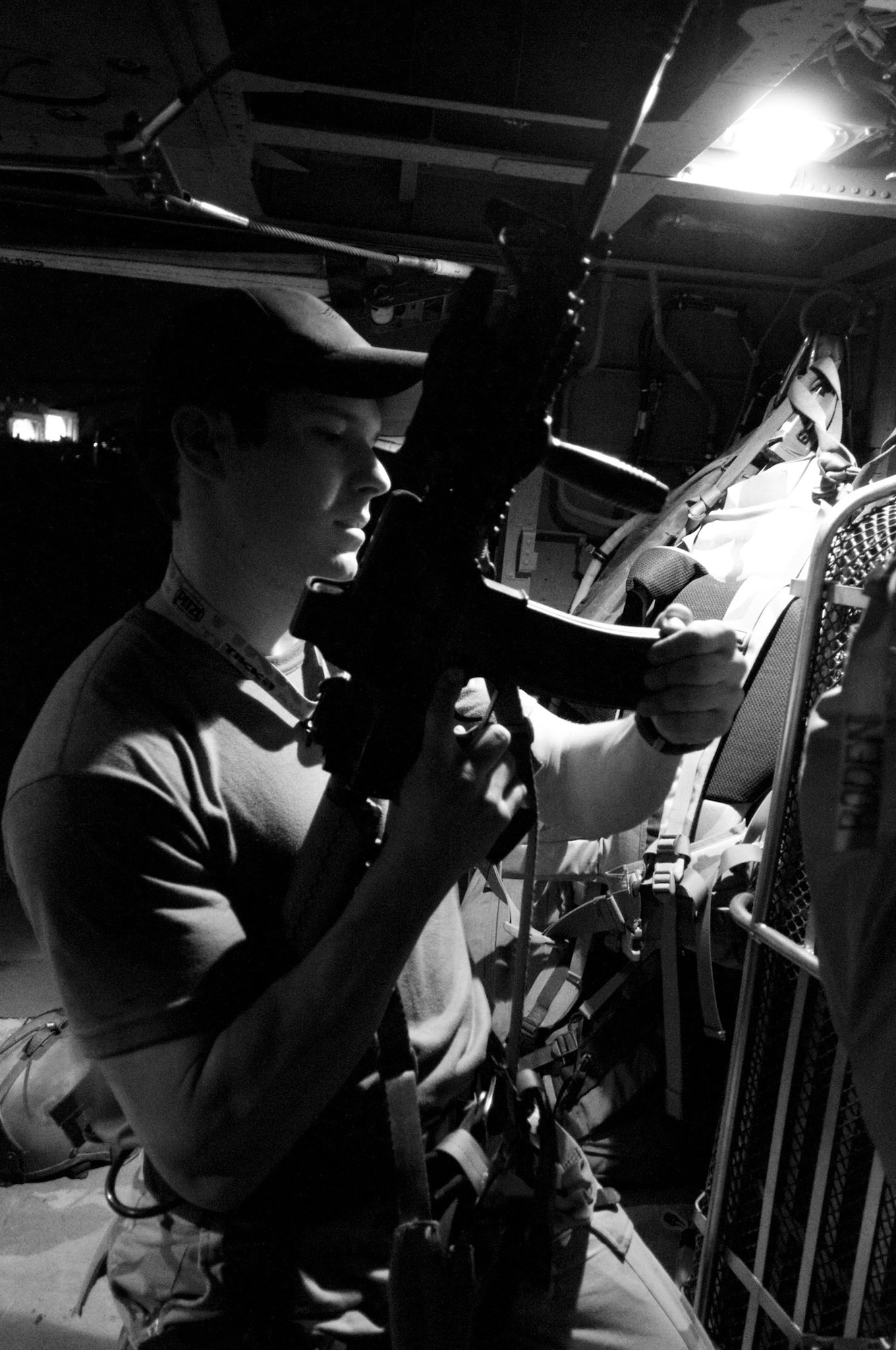 Capt. Brock Roden loads his M-4 rifle in an HH-60G Pave Hawk July 17 at Bagram Air Base, Afghanistan. Captain Roden participated in a combat search and rescue exercise that night. Captain Roden is assigned to the of the 33rd Expeditionary Rescue Squadron deployed from Moody Air Force Base, Ga. (U.S. Air Force photo/Staff Sgt. Samuel Morse) 
