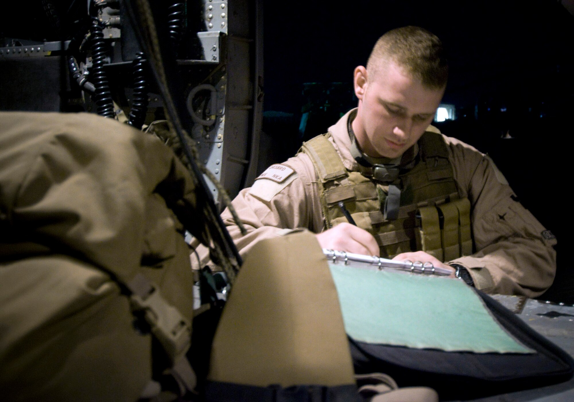 Airman 1st Class Devin Chesbro prepares and checks forms for a flight July 17 at Bagram Air Base, Afghanistan. Airman Chesbro is a 33rd Expeditionary Rescue Squadron flight engineer deployed from Kadena Air Base, Japan. (U.S. Air Force photo/Staff Sgt. Samuel Morse) 
