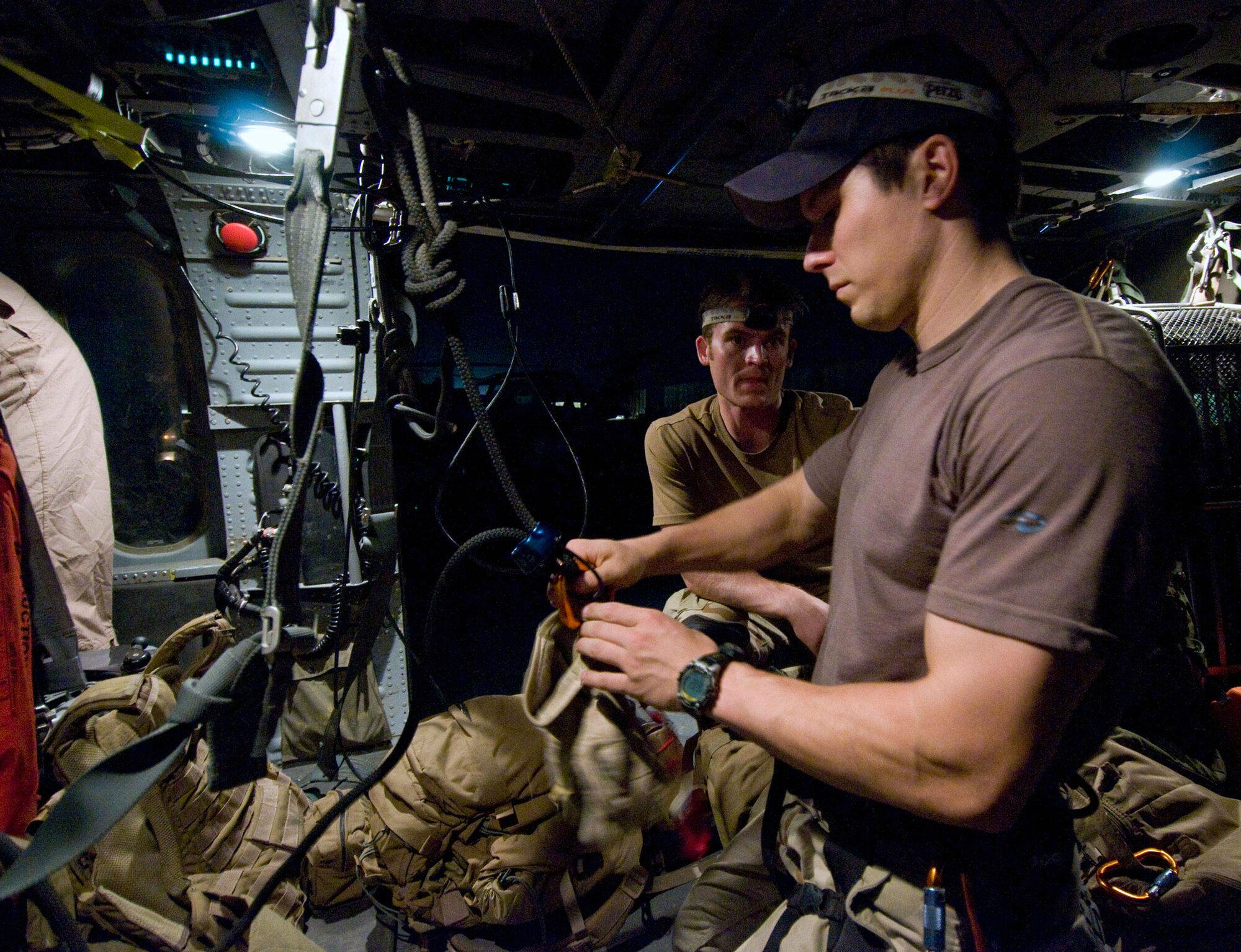 Capt. Brock Roden prepositions gear for flight in an HH-60G Pave Hawk July 17 at Bagram Air Base, Afghanistan. Captain Roden participated in a combat search and rescue exercise that night. Captain Roden is assigned to the of the 33rd Expeditionary Rescue Squadron deployed from Moody Air Force Base, Ga. (U.S. Air Force photo/Staff Sgt. Samuel Morse) 
