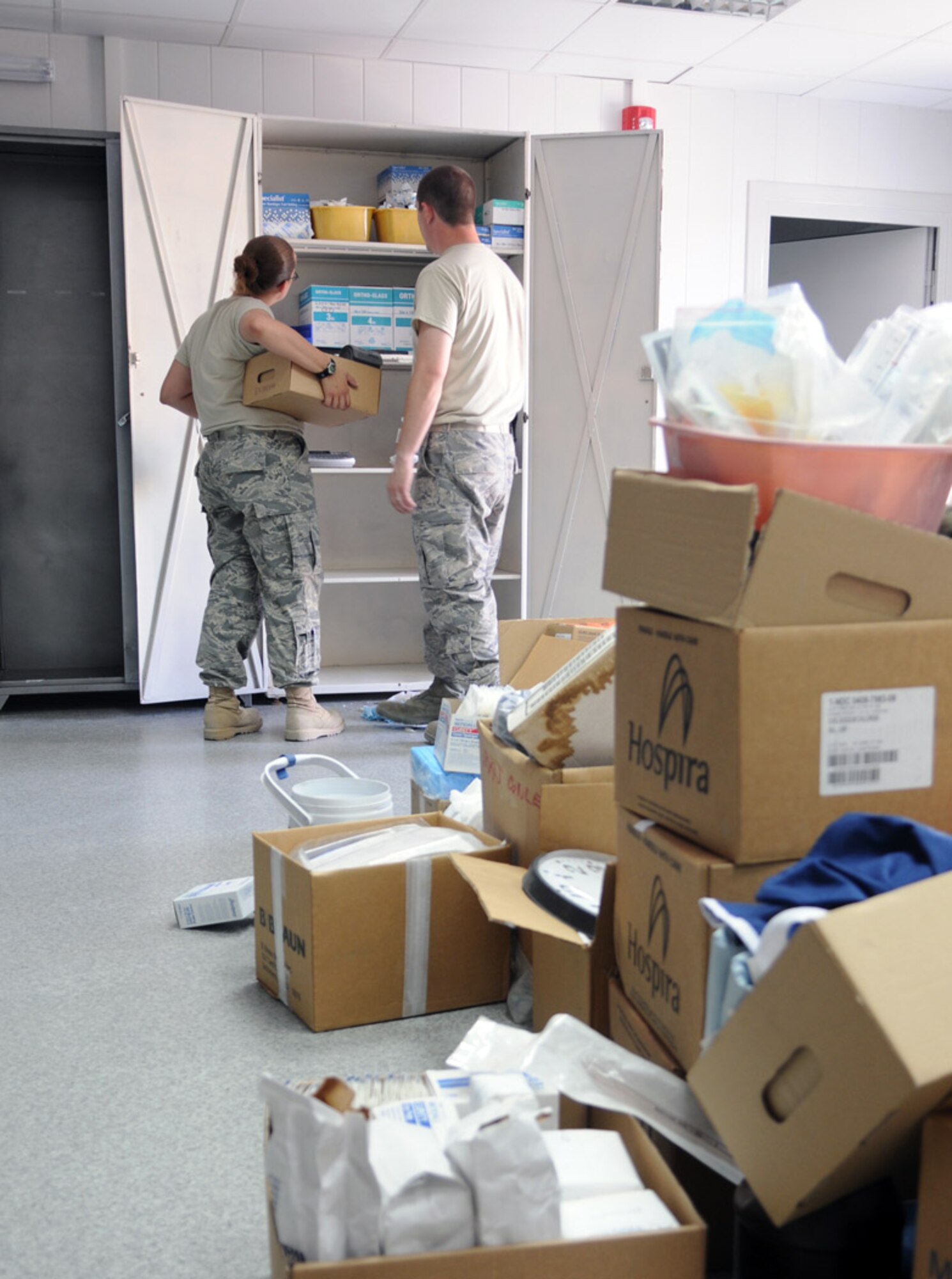 376th Expeditionary Medical Group members move medical supplies into the new medical building July 15 at Manas Air Base, Kyrgyzstan. After nearly seven years operating out of a tent facility, the 376th EMDG moved in to a hardened facility. (Air Force photo/Airman 1st Class Ruth Holcomb) 
