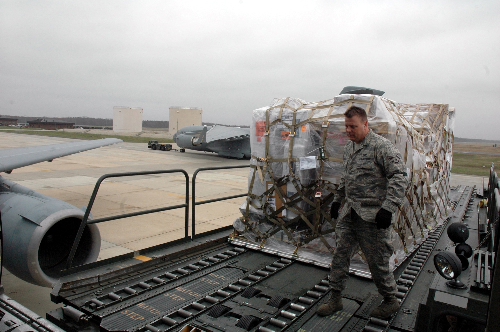 Staff Sgt. Todd Bartley, 305th Aerial Port Squadron, McGuire Air Force Base, N.J., helps move cargo into a KC-10 Extender on McGuire Air Force Base, N.J., April 8, 2008.  McGuire is one of only a few bases to have an aerial port squadron coordinating cargo movements around the world.  (U.S. Air Force Photo/Tech. Sgt. Scott T. Sturkol)