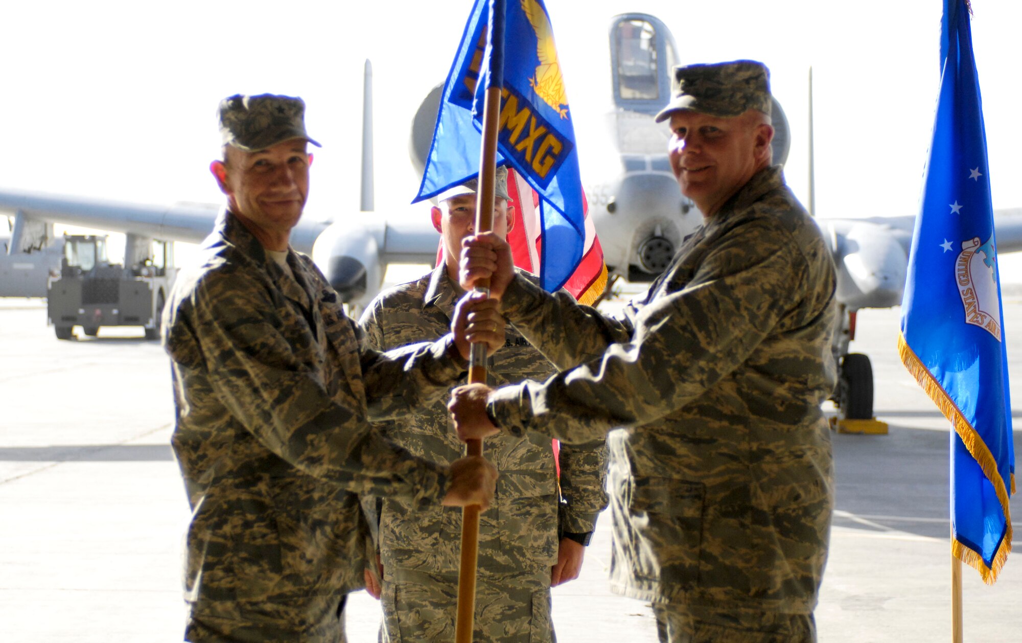 BAGRAM AIR FIELD, Afghanistan -- Col. Clifton Blanks (right), accepts the 455th Expeditionary Maintenance Group guidon from Brig. Gen. Mike Holmes, 455th Air Expeditionary Wing commander, during a change of command ceremony here July 17, 2008. Colonel Blanks deployed from Robins Air Force Base, Ga., to become the new 455th EMXG commander here. (U.S. Air Force photo by Staff Sgt. Rachel Martinez)