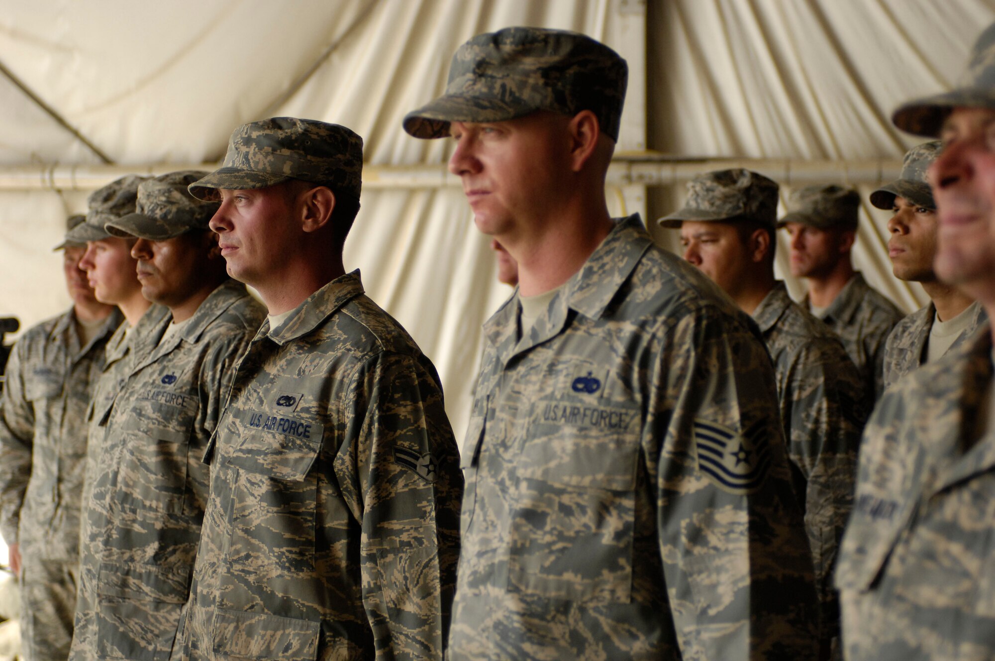 BAGRAM AIR FIELD, Afghanistan -- Airmen from the 455th Expeditionary Maintenance Squadron stand in formation during a change of command ceremony here July 17, 2008. Before relinquishing command of the 455th EMXG to Col. Clifton Blanks, Col. Jon Sutterfield encouraged his maintainers to "keep on fixing to fight." (U.S. Air Force photo by Staff Sgt. Rachel Martinez)