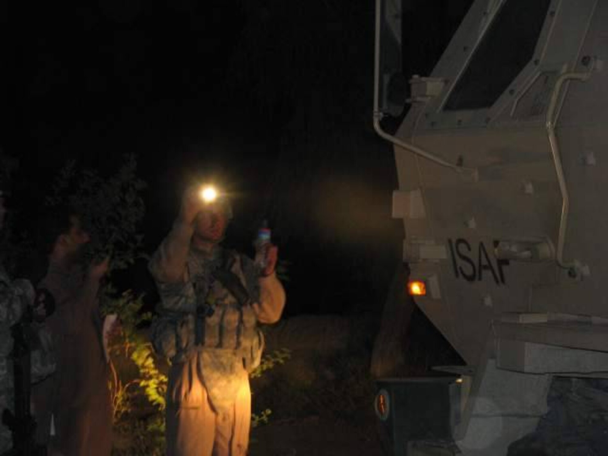 NANGARHAR, Afghanistan -- Tech. Sgt. Jason Williams, Nangarhar Provincial Reconstruction Team mechanic, guides in a Mine Resistant Ambush Protected (MRAP) vehicle during a delivery of emergency humanitarian assistance supplies to residents of the Kuz Kunar and Dari Noor districts of Nangarhar Province, Afghanistan July 3.  The PRT pitched in at the request of the United Nations Assistance Mission in Afghanistan after flash floods struck the area June 30.  (Courtesy photo)