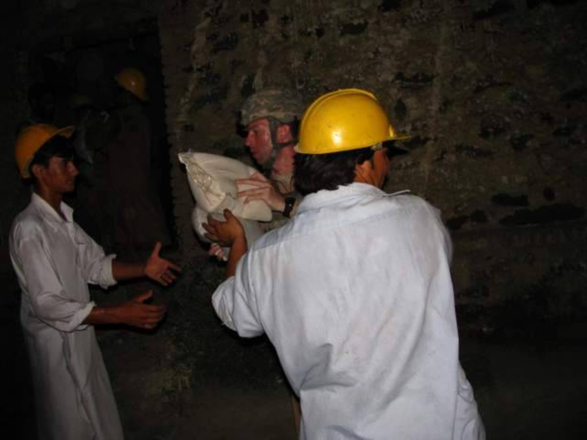 NANGARHAR, Afghanistan -- Air Force Capt. John Morash, Nangarhar Provincial Reconstruction Team, delivers emergency Humanitarian Assistance supplies to residents of the Kuz Kunar and Dari Noor districts of Nangarhar Province, Afghanistan July 3.  The PRT pitched in at the request of the United Nations Assistance Mission in Afghanistan after flash floods struck the area June 30.  (Courtesy photo)