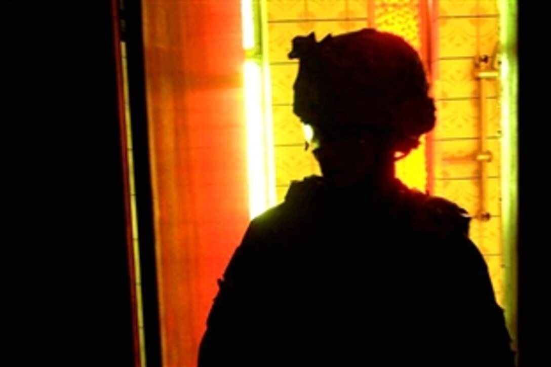 A U.S. Army soldier steps out of a room during a home search in northern Adal, Iraq, July 14, 2008. The soldier is assigned to the 4th Infantry Division's Company B, 1st Battalion, 22nd Infantry Regiment.
