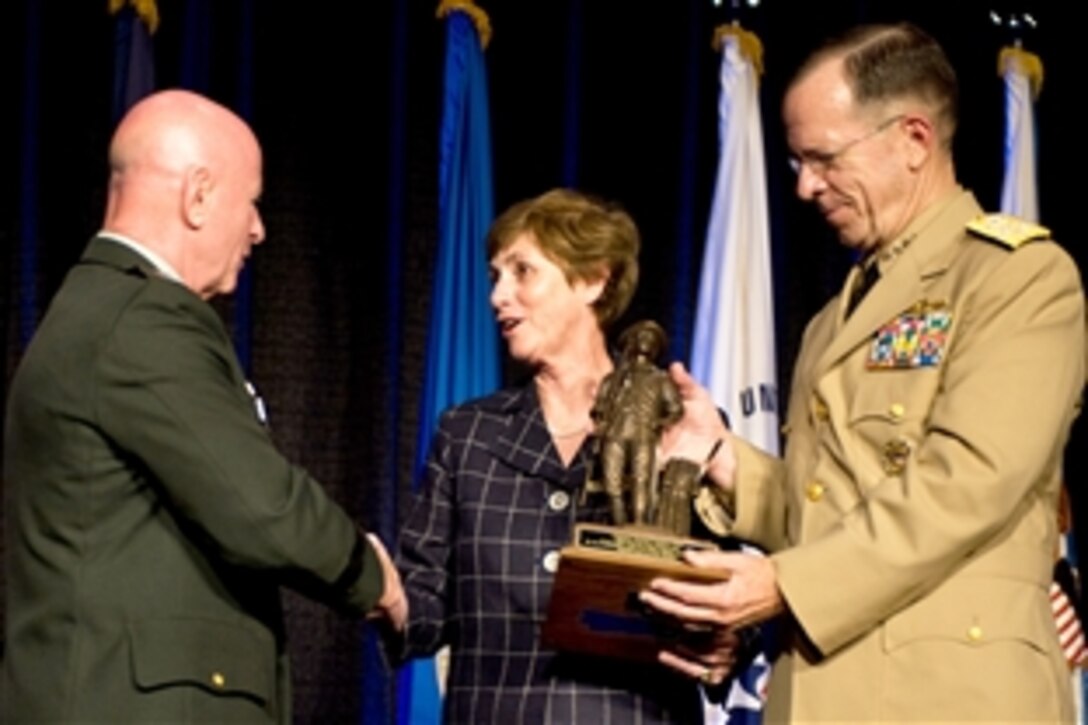 U.S. Army Lt. Gen. H Steven Blum, National Guard Bureau chief, presents U.S. Navy Adm. Mike Mullen, chairman of the Joint Chiefs of Staff, and his wife, Deborah, a Minuteman Statue at the Joint Family Volunteer Workshop and Youth Symposium in St. Louis, Mo., July 21, 2008. More than 1,500 family members participated in four days of workshops, speakers and breakout sessions to promote communication and recognition between families and the National Guard.