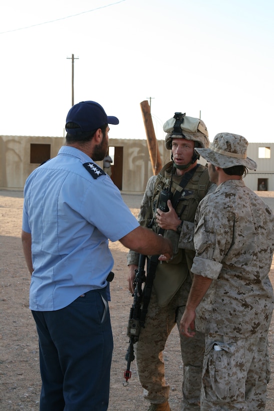 Capt. Joseph Graves, a platoon commander with Company G, 2nd Battalion, 25th Marine Regiment, works with an Iraqi Police Officer to defuse a public disturbance during a training exercise July 21, 2008 at Marine Corps Air Ground Combat Center in Twentynine Palms, Calif.  The exercise was designed to provide Marines the opportunity to work with native-born Iraqi role players in a realistic scenario to prepare them for an upcoming deployment.