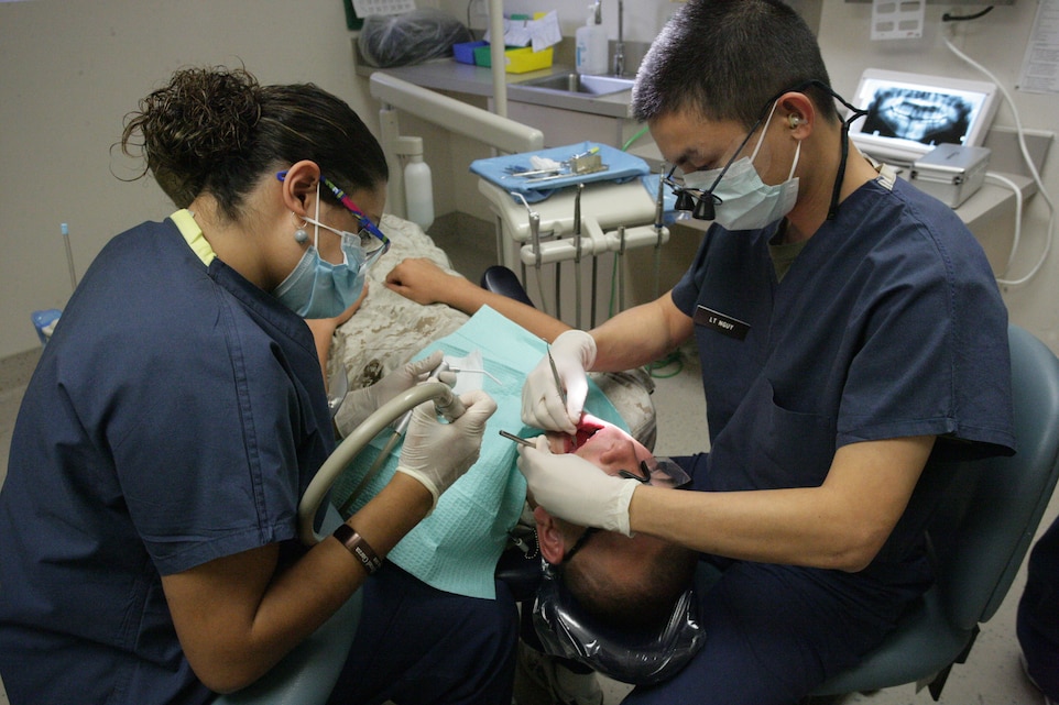 Claudia N. Garza, dental assistant, and Navy Lt. Tom H. Nguy, assistance dental officer, clean a Marine’s teeth at the 23rd Dental Company clinic at the Marine Corps Air Ground Combat Center July 22, 2008. Cleaning and proper hygiene of teeth is a crucial step in preventing tooth decay in an age of soft drinks and easily-accessible snacks. These two elements combined are a major cause of dental problems on base.