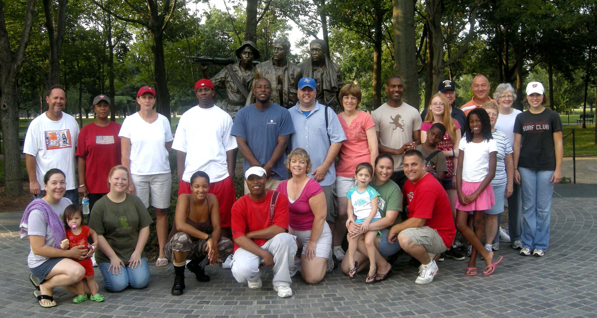 WASHINGTON -- More than 20 members of the 459th Air Refueling Wing, family and other volunteers stand before The Three Soldiers memorial statue here after they stood face to face at dawn with their own reflections while washing more than 58,000 names of service members on the nearly 247-foot Vietnam Memorial Wall July 20. (U.S. Air Force photo/Tech. Sgt. Amaani Lyle)